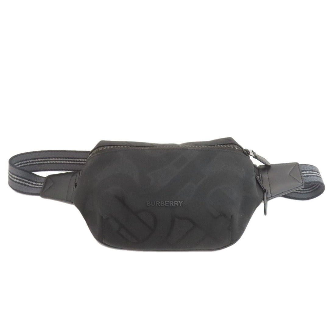 Body Bag Nylon Canvas Burberry Tb Logo: Body Bag Nylon Canvas Burberry Tb Logo Black nylon canvas body bag with the Burberry TB logo. Made from a durable nylon canvas exterior, this bag features a classic design. The Burberry TB logo is