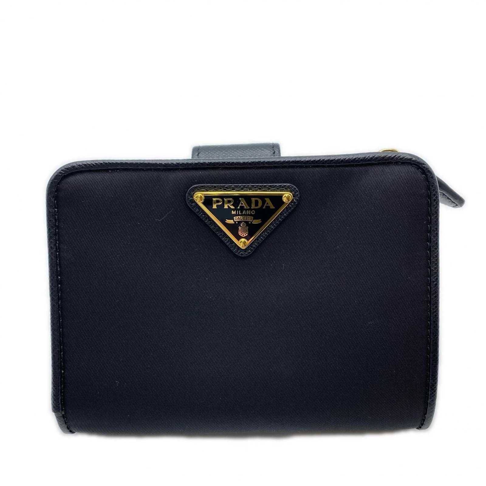 Saffiano Bi Fold Nylon Wallet: Saffiano Bi Fold Nylon Wallet Saffiano Bi Fold Nylon Wallet. Made from durable Saffiano nylon, this bi-fold wallet features RFID-blocking technology for added security. With its sleek black design and
