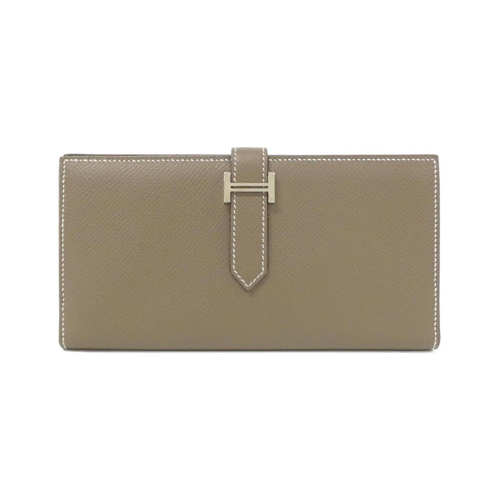 Epsom Leather Bi fold Wallet Hermes: Epsom Leather Bi fold Wallet Hermes Epsom leather, a rich and luxurious material, is used to craft this bi-fold wallet from Hermes. The wallet's distinctive Etoupe gray and Soufre color combination