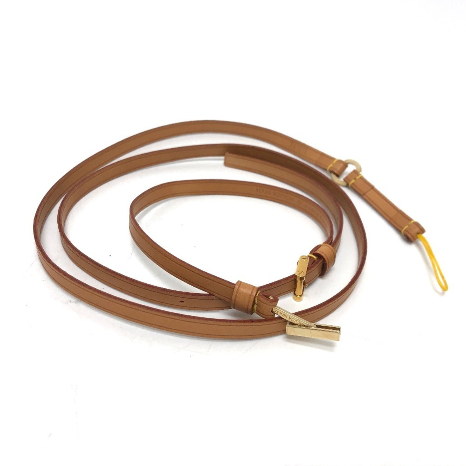 Leather Strap Louis Vuitton: Leather Strap Louis Vuitton Vachetta leather strap from Louis Vuitton, measuring 8.00mm x 109cm, is a distinctive accessory. This beige-colored strap comes with a dust bag for storage. The strap's
