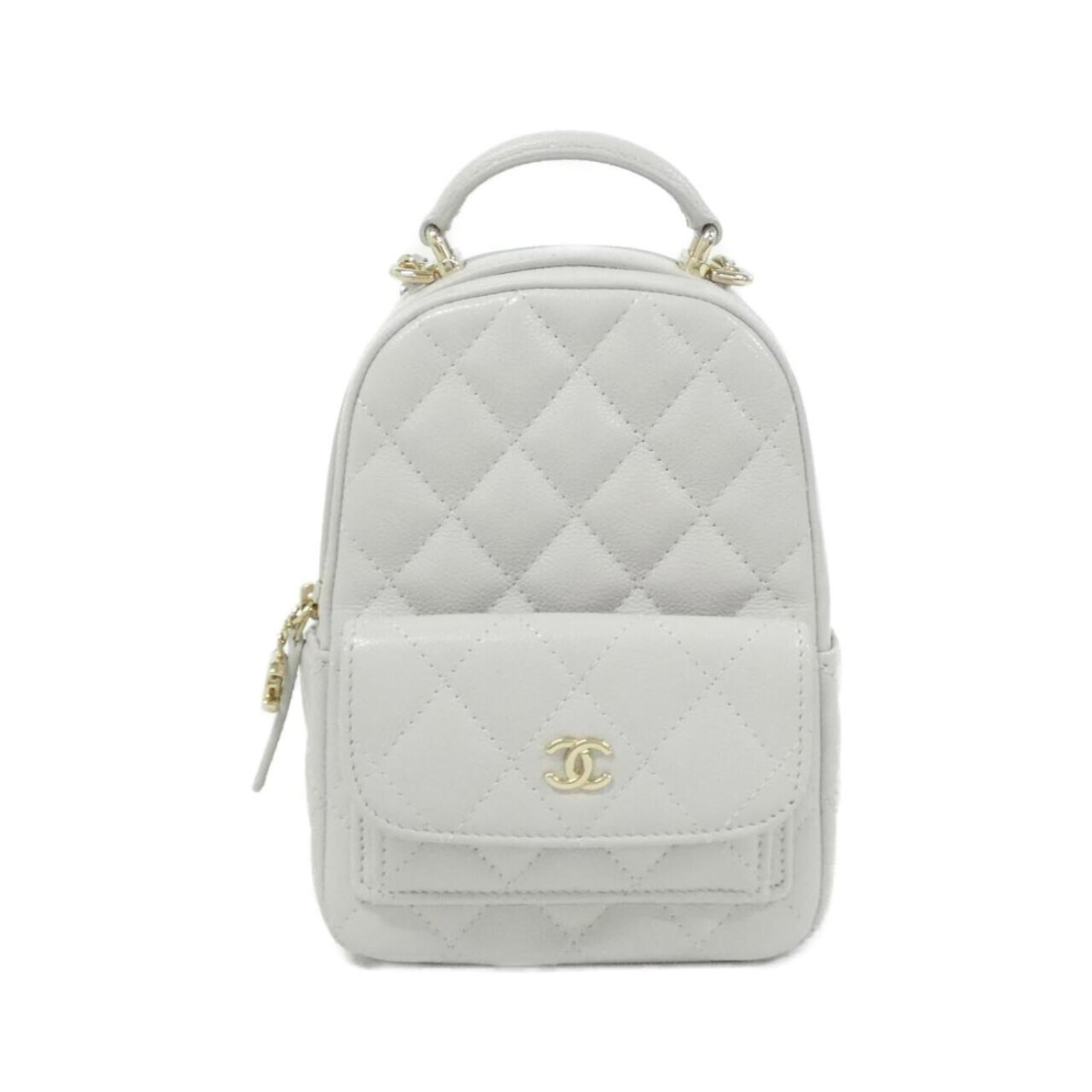 Calfskin Grained Chanel Backpack: Calfskin Grained Chanel Backpack Calfskin Grained Chanel Backpack is a stylish and durable accessory made from high-quality light gray grained calfskin. The gold hardware adds a touch of