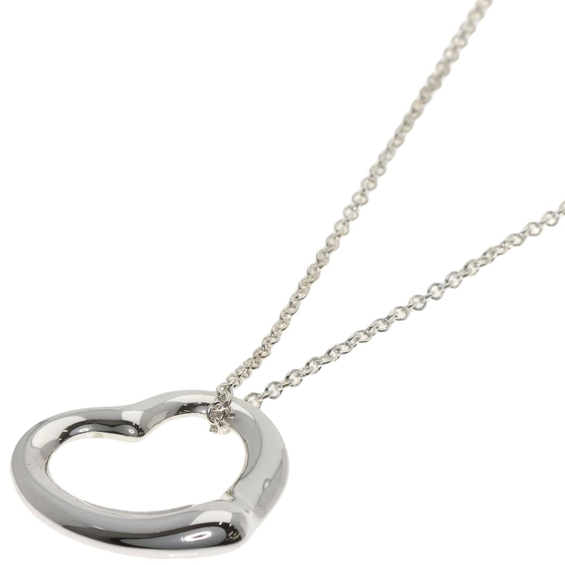 Open Heart Necklace by Tiffany & Co: Open Heart Necklace by Tiffany & Co The Open Heart Necklace by Tiffany & Co. is a sleek and modern design featuring a silver metal exterior. This 15.7-inch long necklace boasts a striking silver color