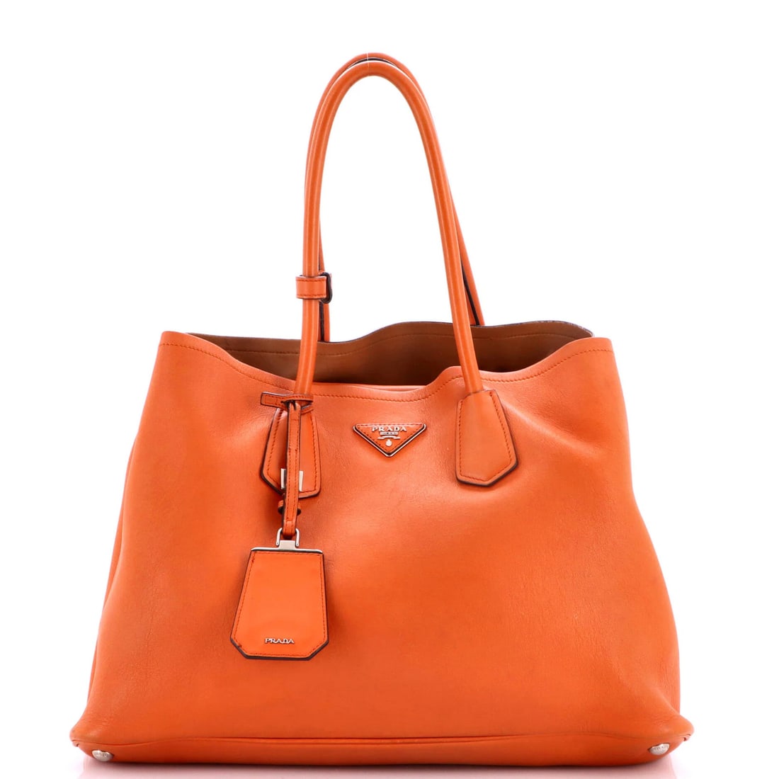 Large Leather Tote Prada Cuir Double: Large Leather Tote Prada Cuir Double Large Leather Tote Prada Cuir Double in Orange, featuring a spacious interior and silver hardware, with a signature on the interior. The exterior showcases a