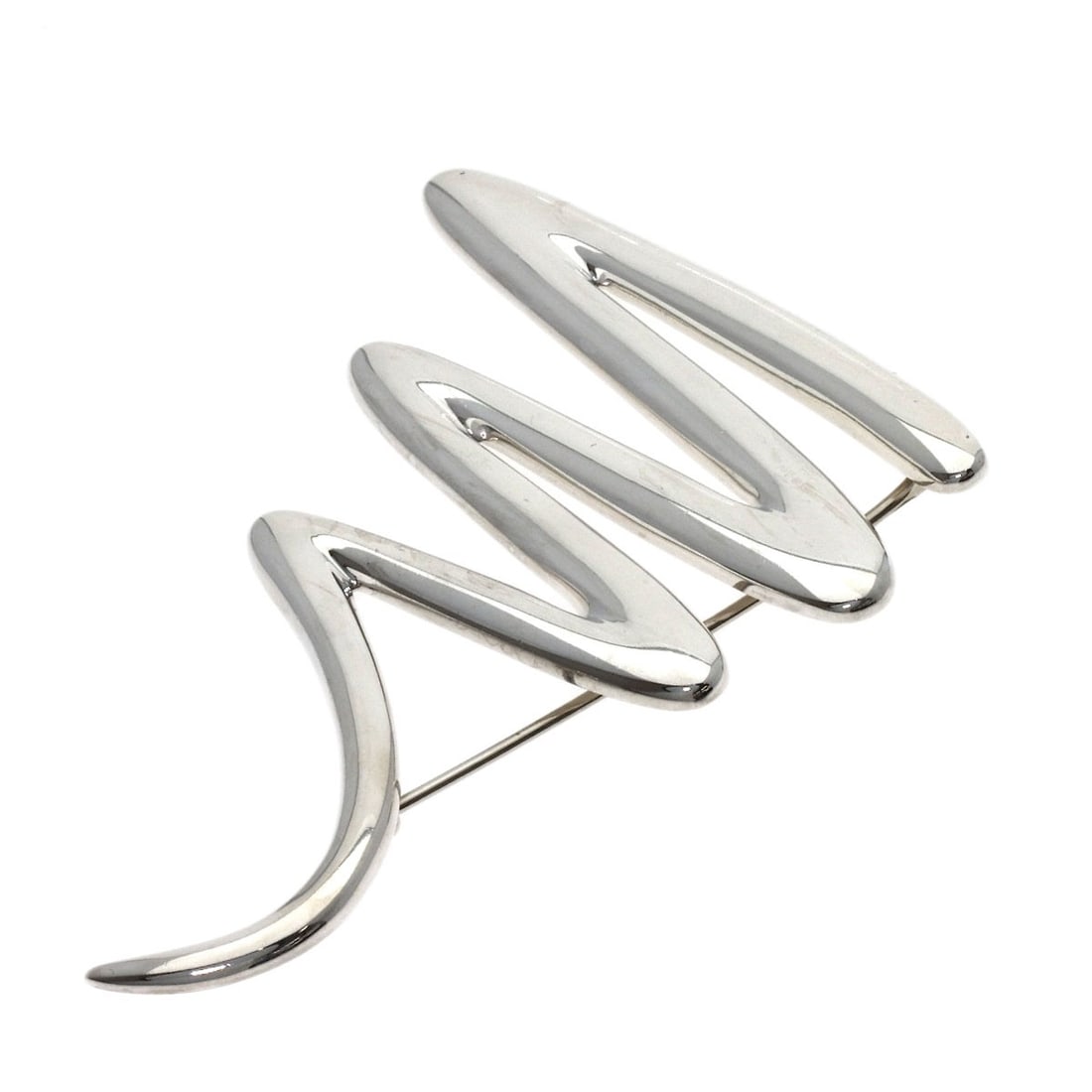 Tiffany Co Scribble Silver Brooch: Tiffany Co Scribble Silver Brooch Silver Scribble Brooch by Tiffany & Co. features a striking silver design. The brooch bears a signature, adding a touch of elegance to any outfit. Its sleek silver