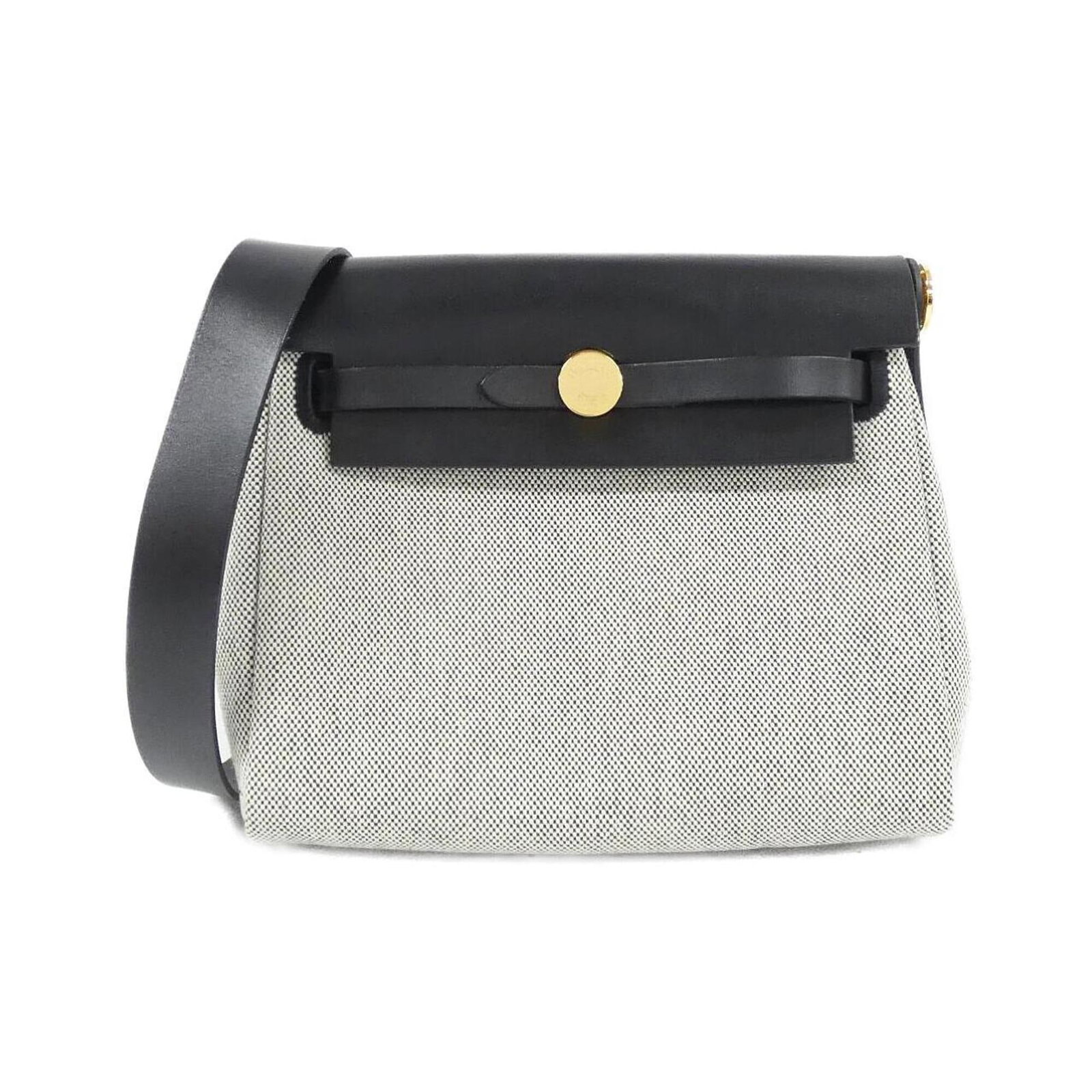 Shoulder Bag By Hermes: Shoulder Bag By Hermes Black and ecru tones come together in this sleek shoulder bag from Hermes, with gold hardware adding a touch of luxury. Measuring 16cm x 20cm x 6cm, it's a compact and stylish