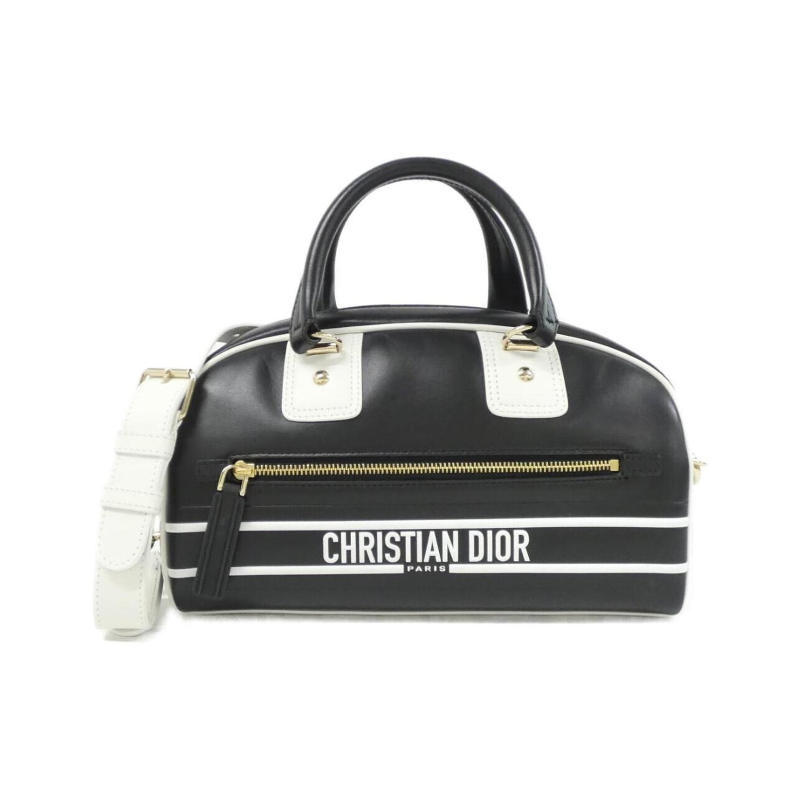 Handbag Leather Dior Christian: Handbag Leather Dior Christian This black and white Christian Dior handbag features a classic design with a gold hardware accent. Made from high-quality calfskin leather, the bag's sleek and
