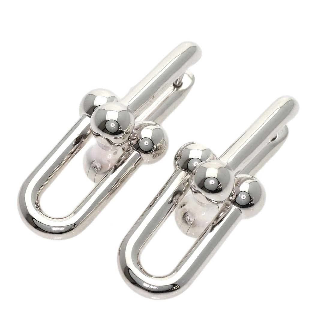 Tiffany Co Hardware Silver Earring: Tiffany Co Hardware Silver Earring Silver Tiffany Co hardware earring with an open closure, showcasing a sleek and modern design. This earring features a silver metal construction and a silver