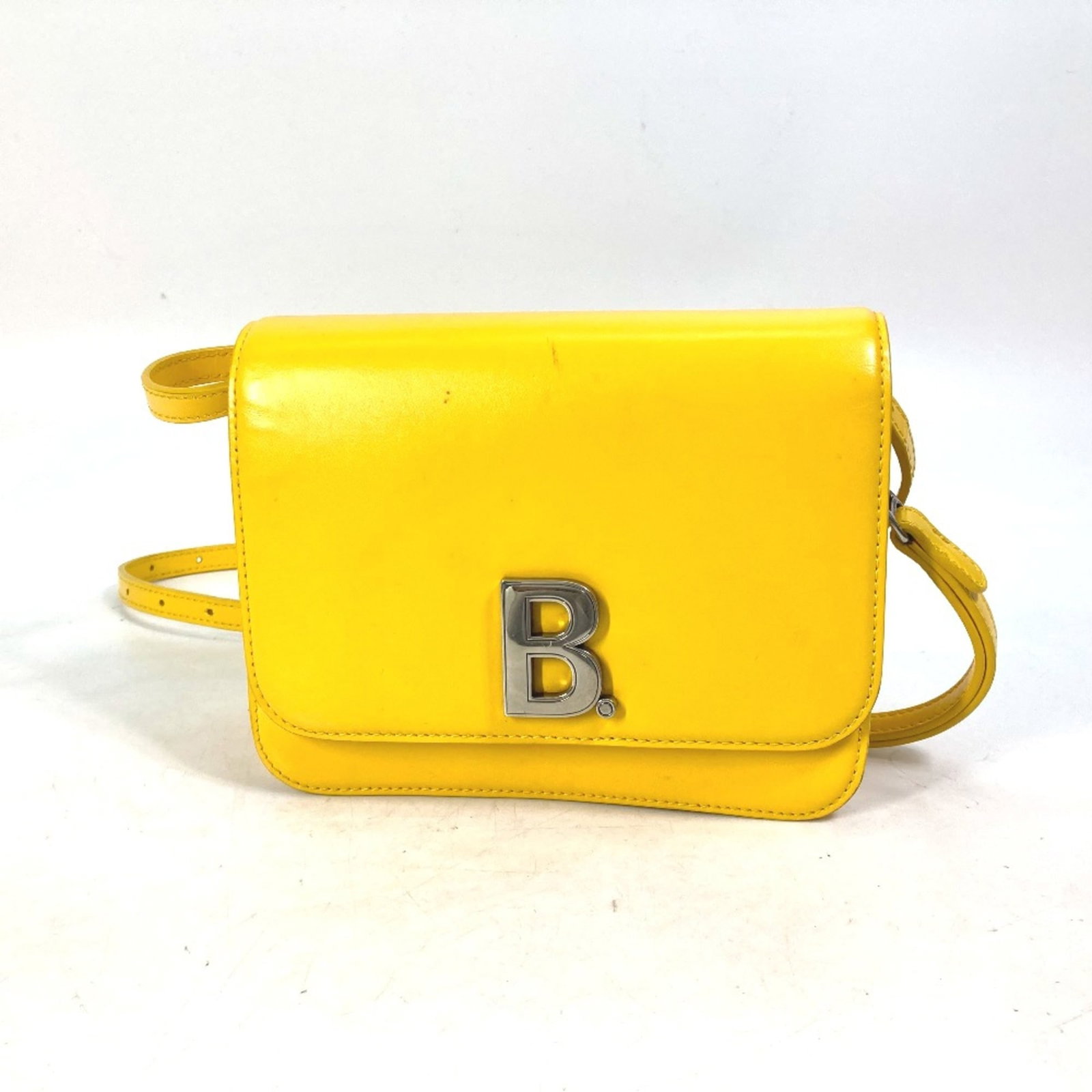 Bag Shoulder Leather Balenciaga: Bag Shoulder Leather Balenciaga Bag Shoulder Leather Balenciaga is a yellow leather shoulder bag with a size of W17.5cmxH14.5cmxD5.5cm/W6.9xH5.7xD2.2inch. The bag features a long shoulder strap that