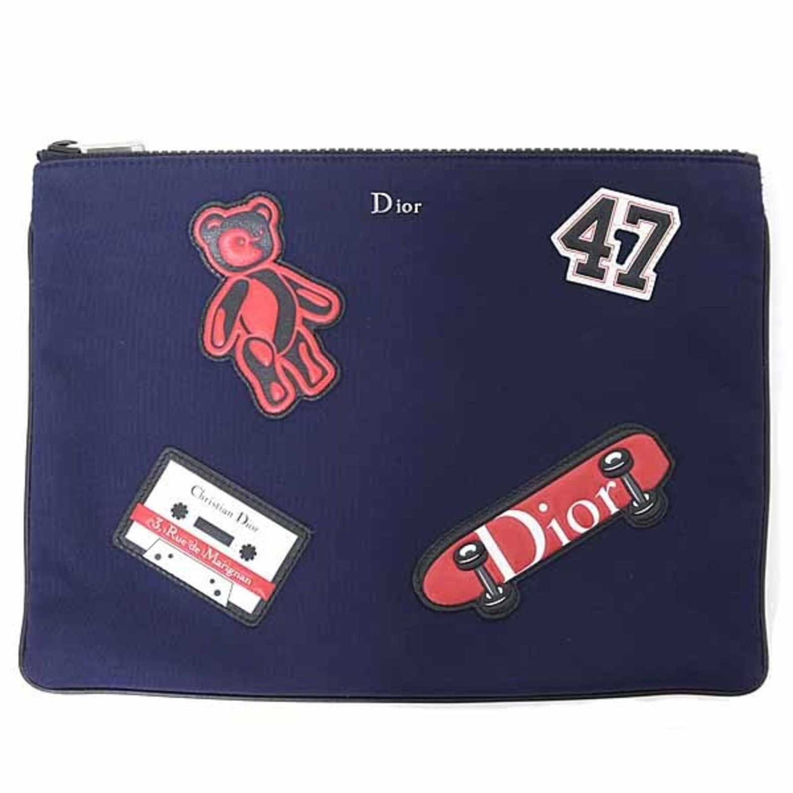 Nylon Dior Pouch Christian: Nylon Dior Pouch Christian Navy nylon Dior Pouch with a bold red accent, this Italian-made pouch features a striking color combination and a sleek design. Measuring 19.5cm x 26cm, it offers a compact