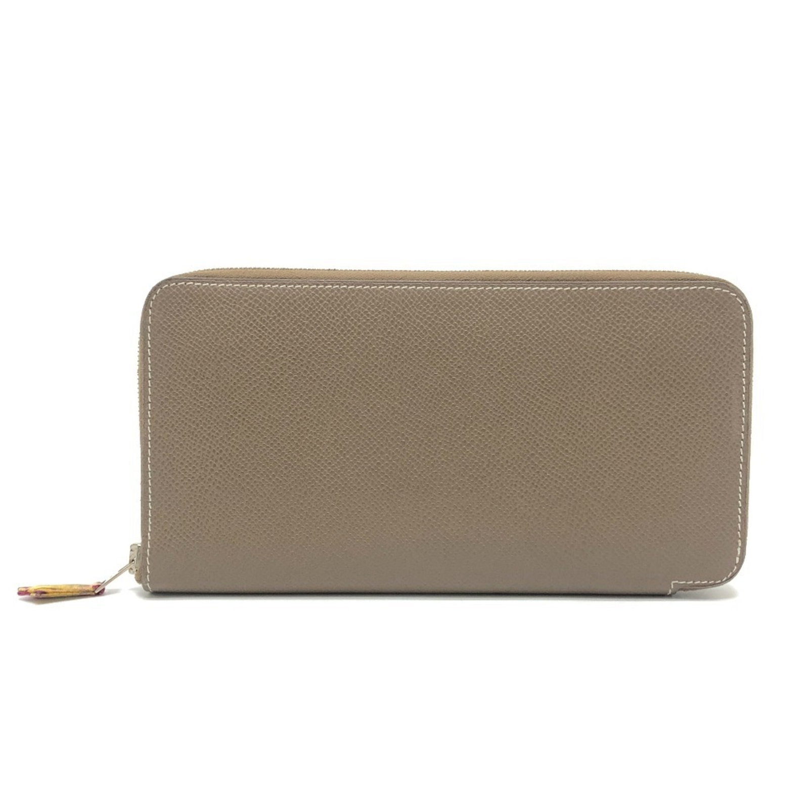 Epsom Leather Bi fold Wallet Hermes: Epsom Leather Bi fold Wallet Hermes Epsom leather bi-fold wallet from Hermes, crafted in France with a rich brown and Etoupe gray color combination. This long wallet features a classic design with a
