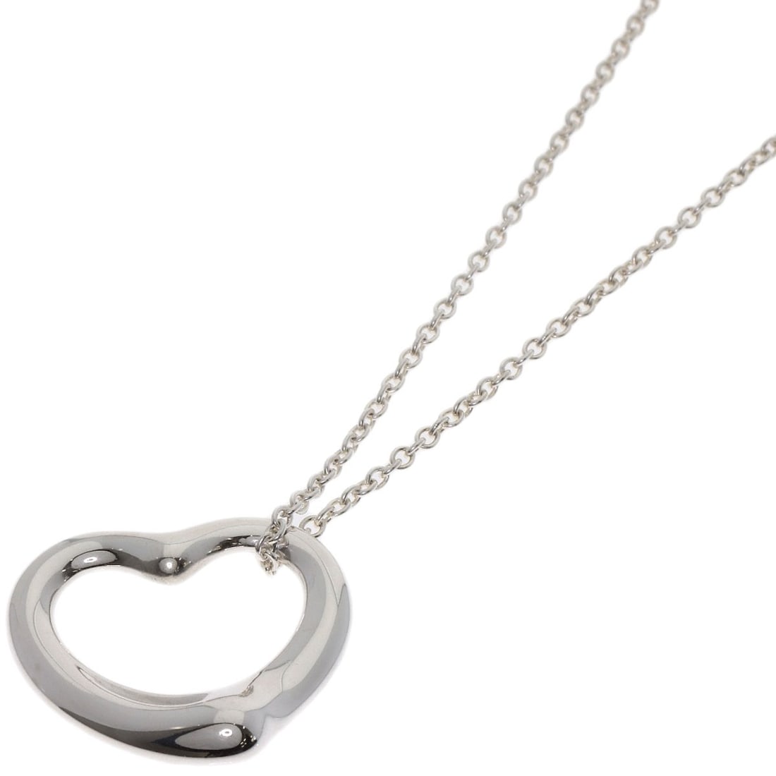 Open Heart Necklace by Tiffany & Co: Open Heart Necklace by Tiffany & Co The Open Heart Necklace by Tiffany & Co. is a sleek and modern design featuring a silver metal exterior. This 15.7-inch long necklace boasts a striking silver color