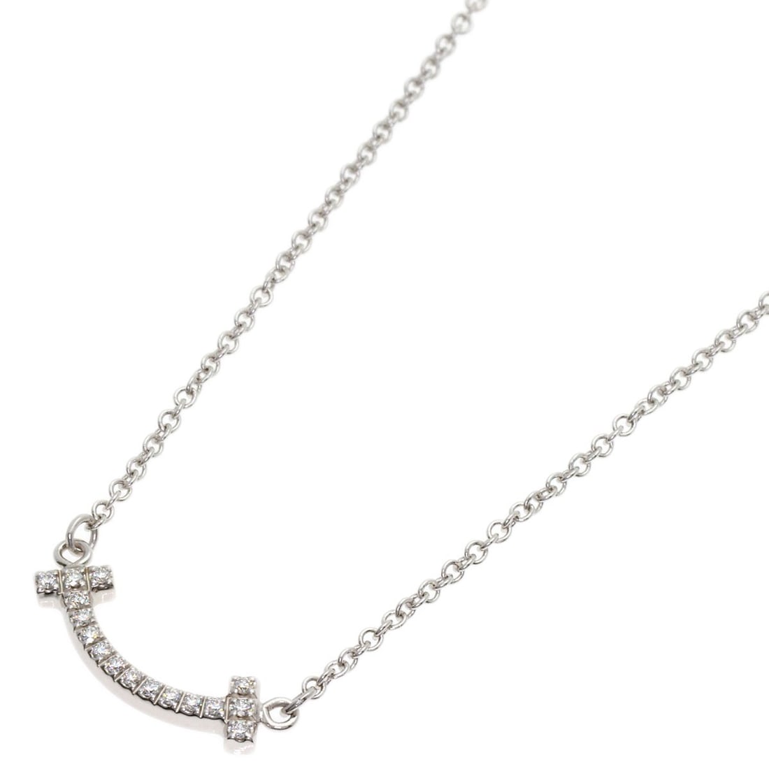 T Smile Mini Diamond Necklace in White Gold K18 Tiffany&Co: T Smile Mini Diamond Necklace in White Gold K18 Tiffany&Co T Tiffany&Co's K18 White Gold Mini Diamond Necklace boasts a striking 17.9-inch length and a delicate design, featuring a single diamond set 