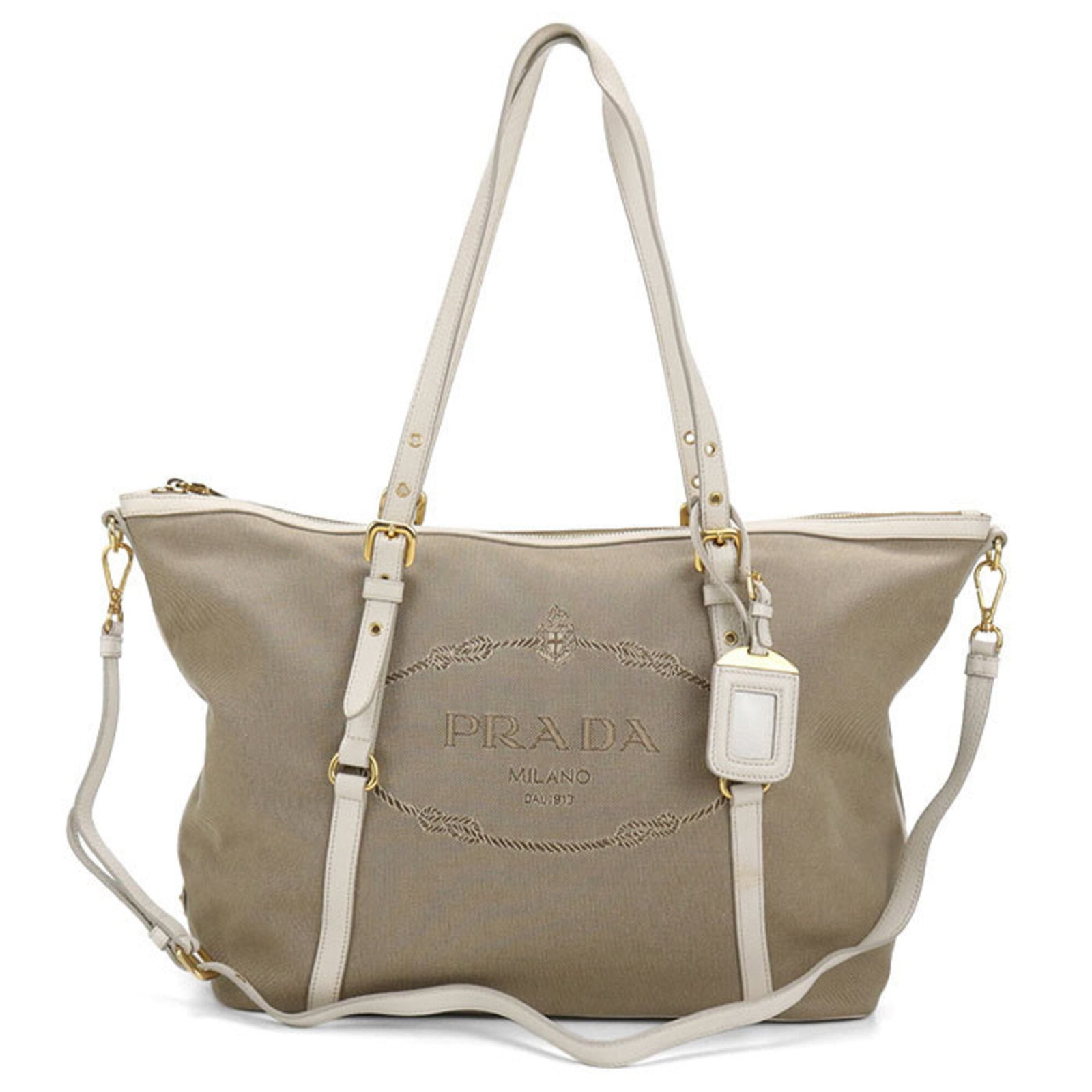 Canvas Prada Tote: Canvas Prada Tote Canvas Prada Tote, a stylish and versatile bag from the iconic Italian brand, boasts a classic beige canvas design with gold hardware, perfect for everyday use. Measuring 29cm x
