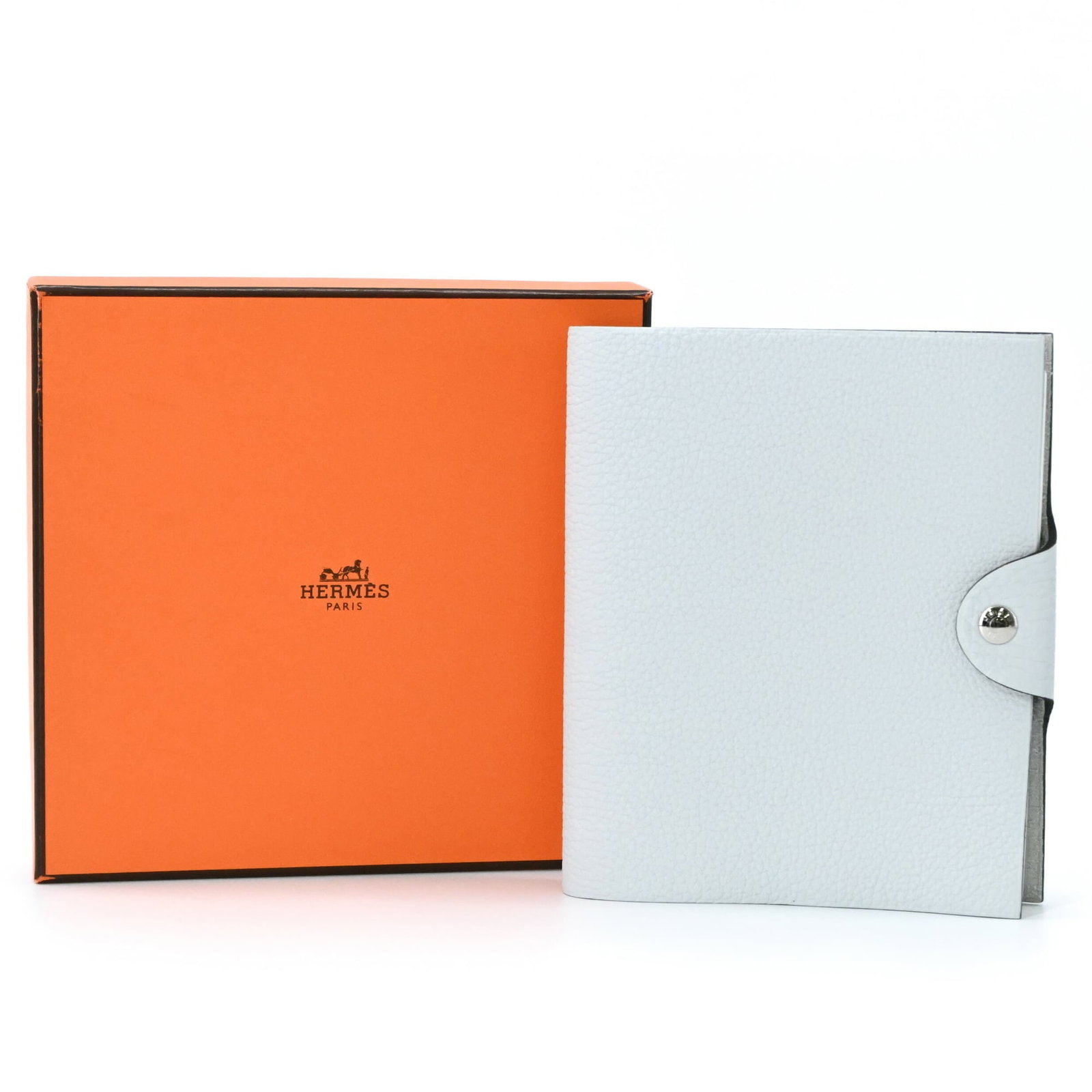 Clemence Taurillon Pale Blue Leather Pm Notebook Hermes Ulysses Cover: Clemence Taurillon Pale Blue Leather Pm Notebook Hermes Ulysses Cover Compact and elegant, this 16cm x 13cm x 1.5cm Ulysse notebook from the iconic Hermes brand features a stunning Taurillon clemence 