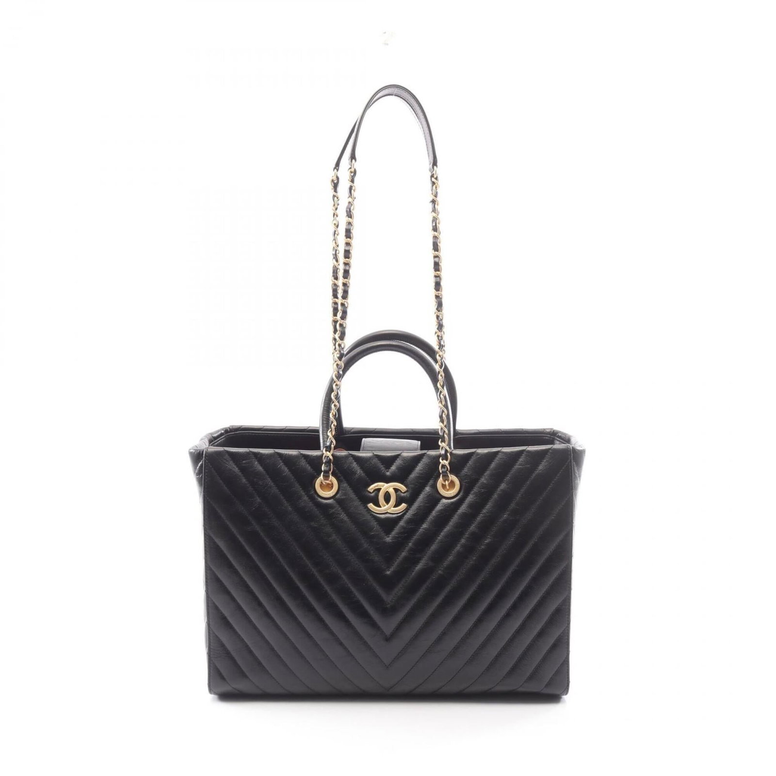 Chanel Handbag Leather Tote: Chanel Handbag Leather Tote Black leather Chanel handbag with gold hardware, measuring 25cm x 36cm x 16cm. This classic tote bag features high-quality leather construction and elegant gold accents. In