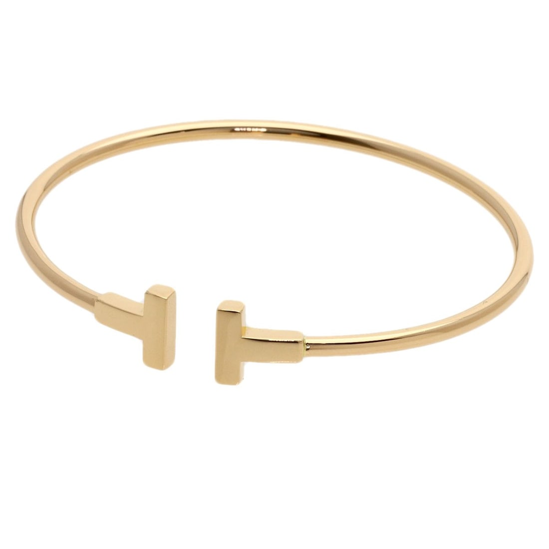K18 Pink Gold Twire Tiffany&Co.: K18 Pink Gold Twire Tiffany&Co. K18 Pink Gold Twire Tiffany&Co. bracelet boasts a sleek, gold metal design with a distinctive twire pattern. This K18 pink gold piece is a masterclass in understated
