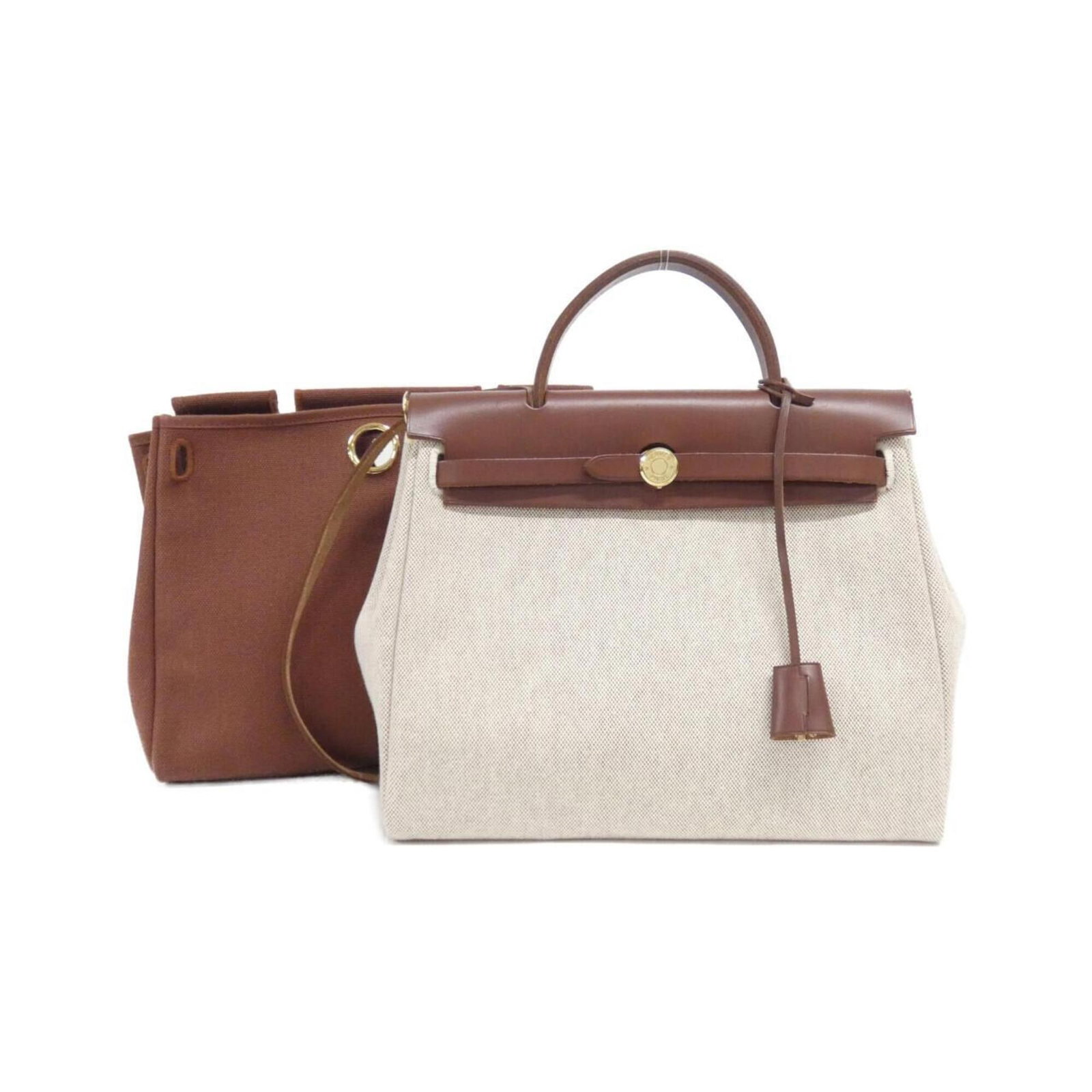 Handbag Hermes Toile: Handbag Hermes Toile The iconic Toile de Herm?s handbag boasts a timeless design, with its classic Havane leather and gold hardware creating a sophisticated look. Measuring 26cm x 30cm x 10cm, this