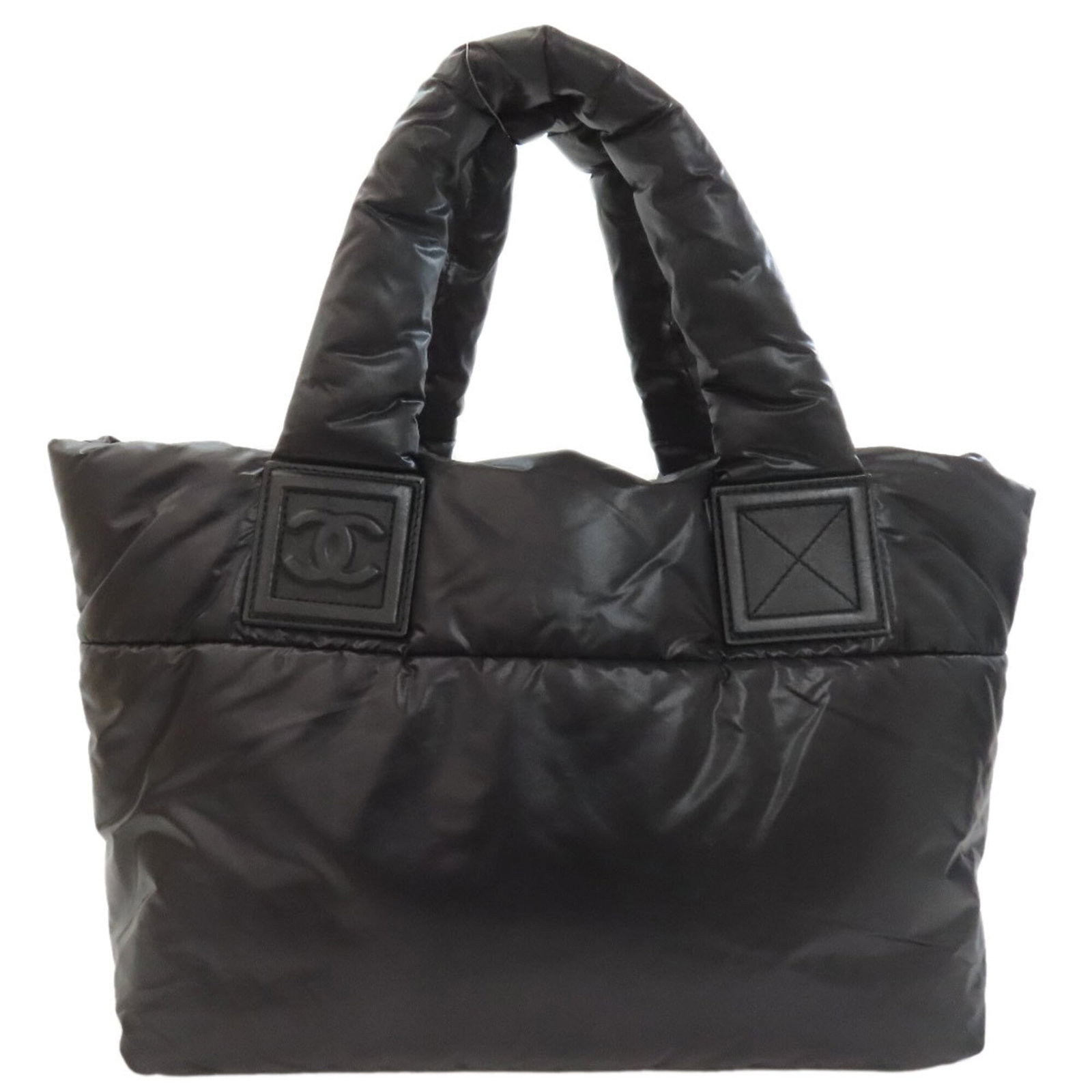 Nylon Tote Bag By Chanel: Nylon Tote Bag By Chanel Nylon tote bag by Chanel, featuring a sleek black design with a size of 23.5cm x 30cm x 14.5cm. Made from high-quality nylon, this bag boasts a compact and stylish