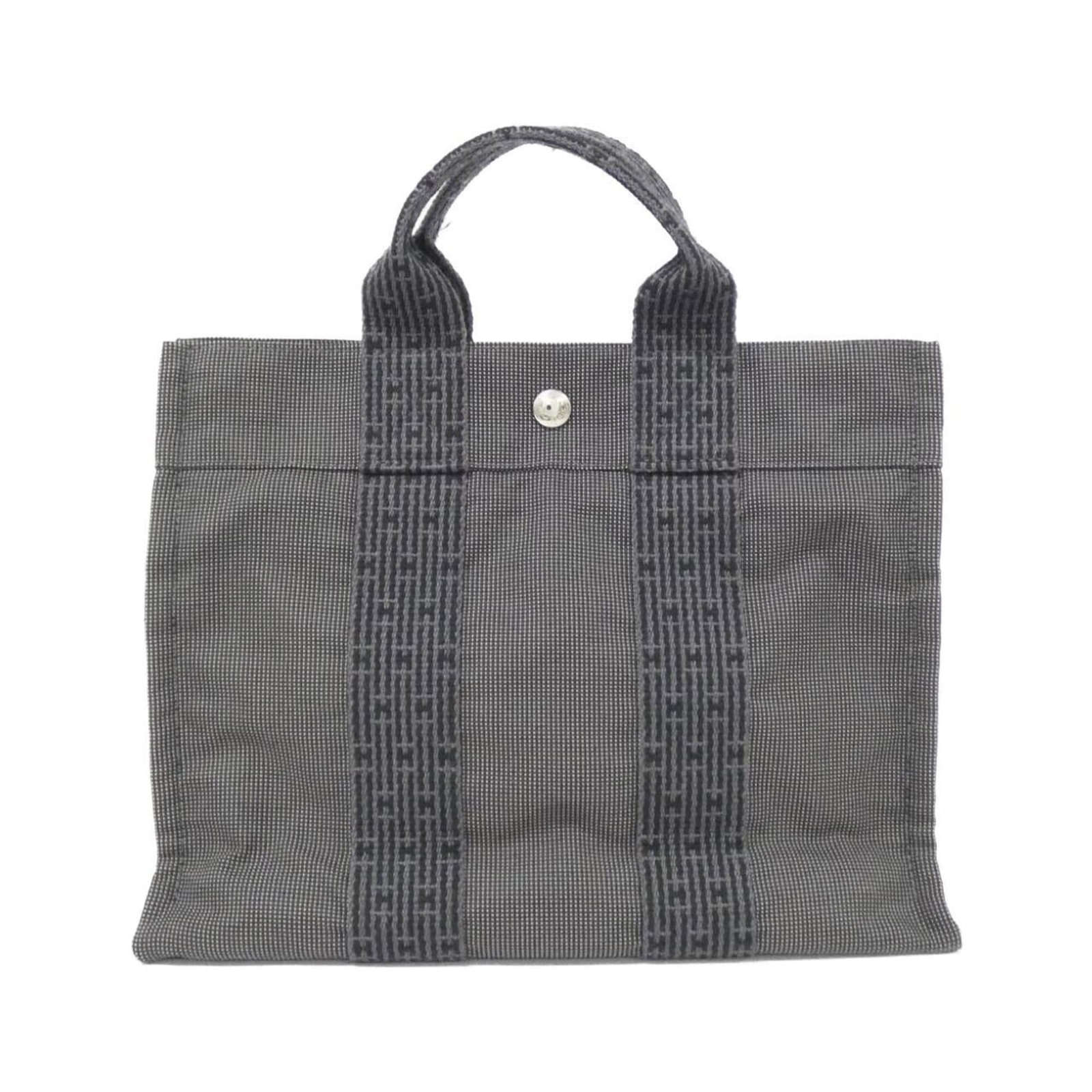 Handbag Canvas: Handbag Canvas Canvas handbag with a sleek black finish, measuring 23cm x 31cm x 8cm. The canvas material provides a sturdy and durable structure, while the signature bears a distinctive mark. This