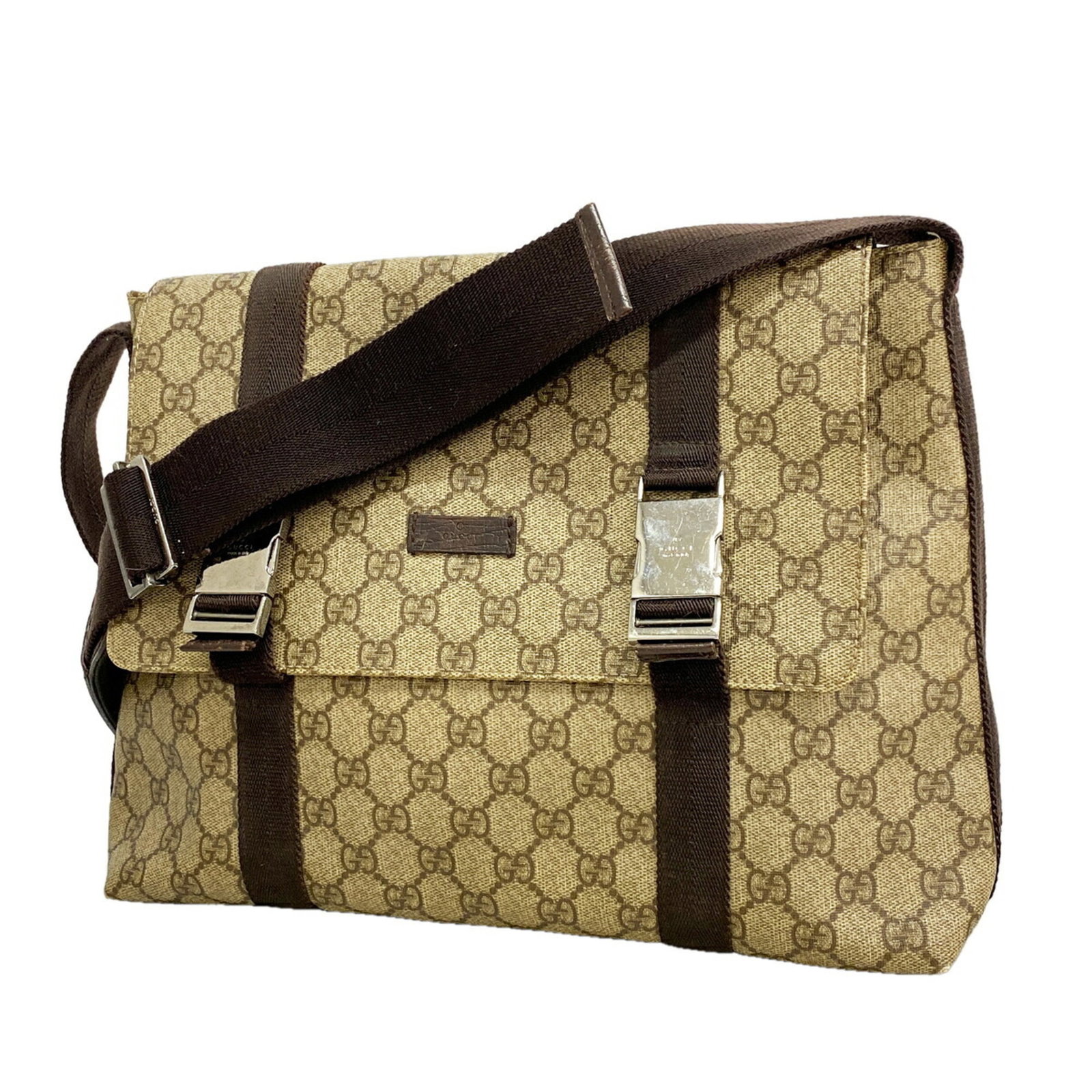 Shoulder Bag Pvc Gucci: Shoulder Bag Pvc Gucci This Gucci shoulder bag is made from PVC and features a classic brown color with silver hardware. The bag measures 27cm x 32cm x 10cm and has a sleek, modern design. The bag's