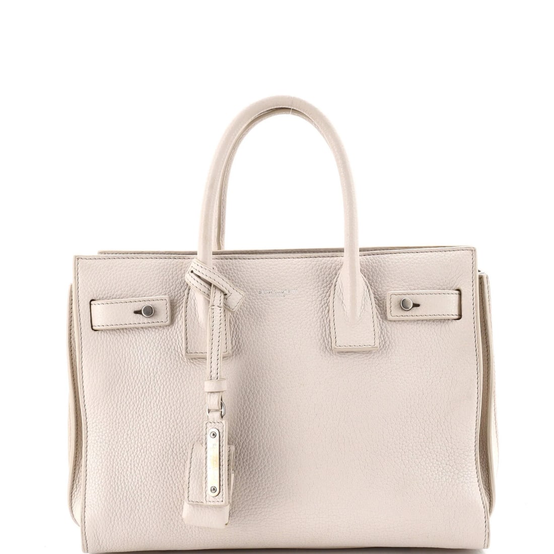 Leather Baby Bag Sac Souple Saint Laurent: Leather Baby Bag Sac Souple Saint Laurent White leather Sac de Jour Souple Bag features a top handle and comes with a clochette, keys lock, and strap. The bag measures 7.5" tall, 10" wide, and 3"