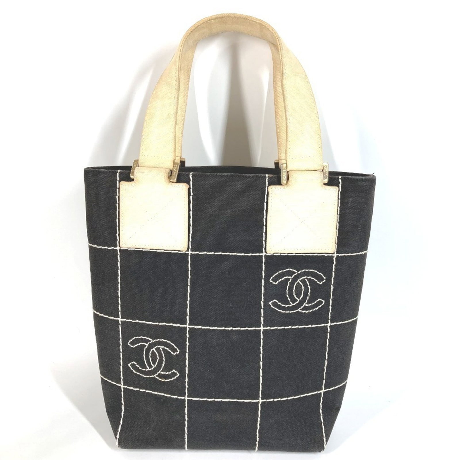 Chanel Handbag Shoulder Bag Tote Bag Cotton: Chanel Handbag Shoulder Bag Tote Bag Cotton This black and white Chanel shoulder bag tote bag is made from cotton, with a size of 24cm x 18.5cm x 9.5cm. The bag's country of origin is Italy, and it