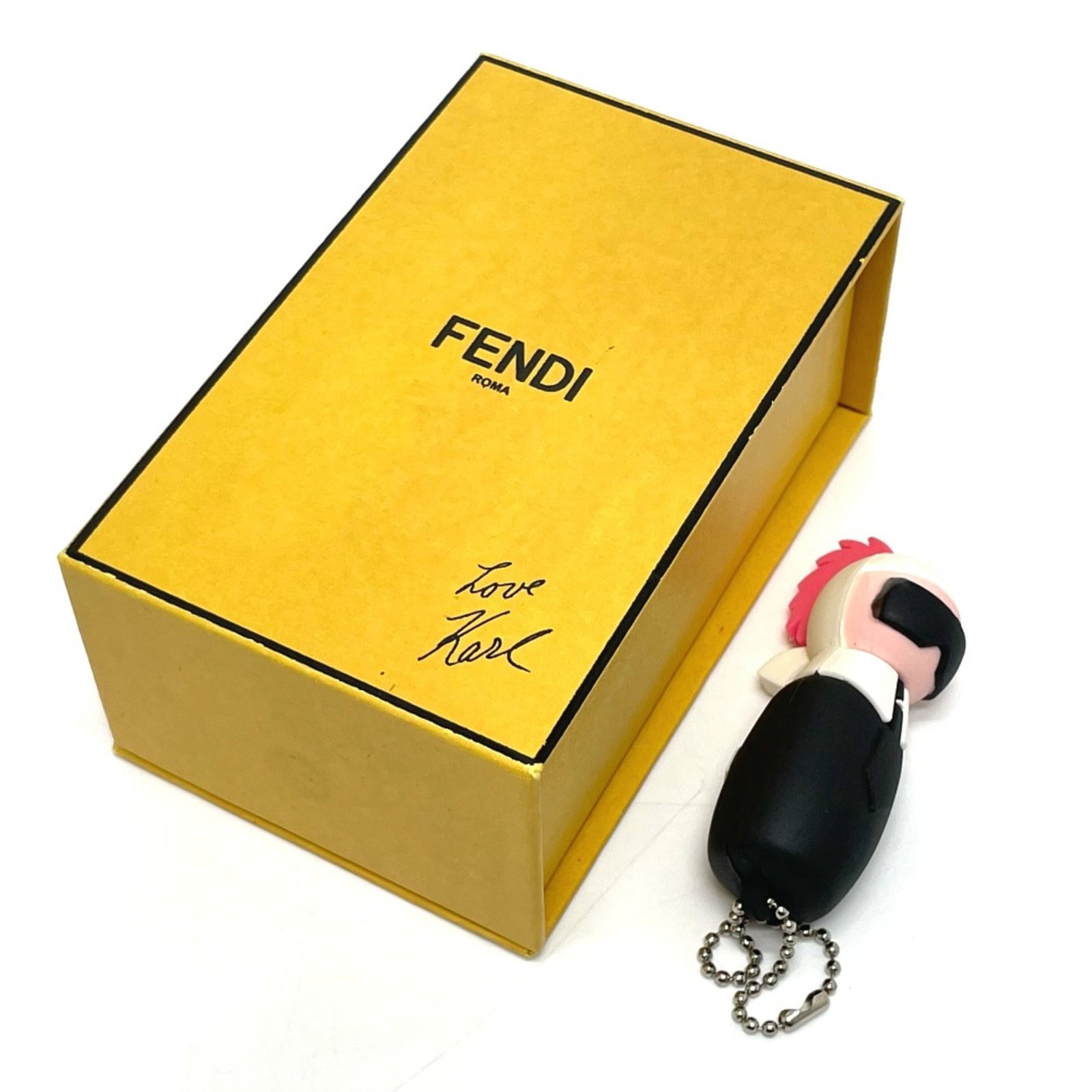 Keyring Fendi: Keyring Fendi The Fendi keyring is a sleek and sophisticated accessory, measuring 2cm x 6cm in width and 0.8cm x 2.4cm in height. Crafted from a unique material, this black keyring boasts a