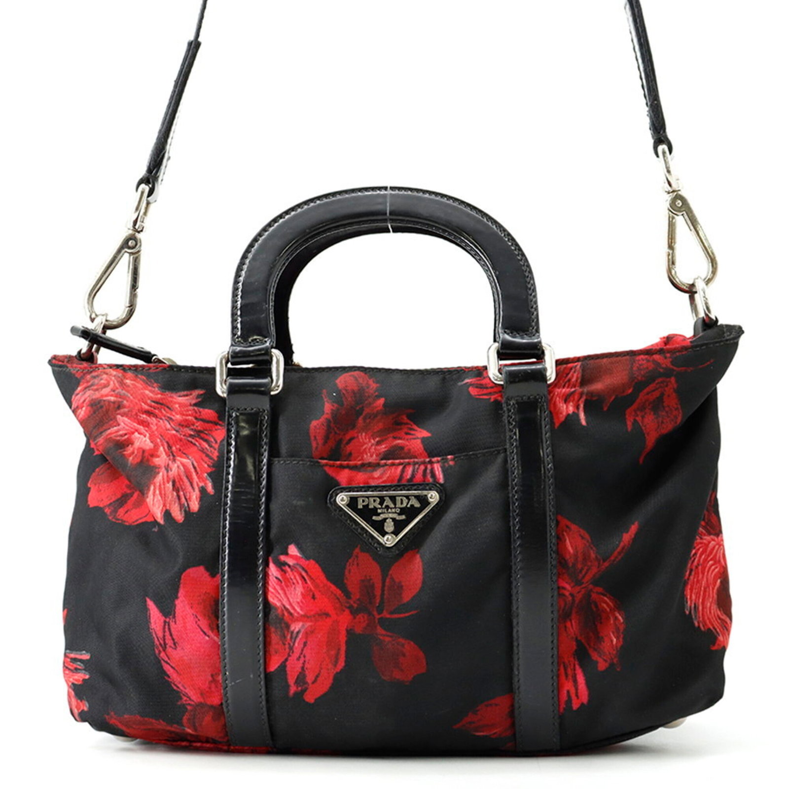 Handbag Nylon Leather Prada: Handbag Nylon Leather Prada Nylon and leather blend in this sleek, black Prada handbag, featuring silver hardware and a compact 16.5cm x 25.5cm x 7cm size. The bold red accent adds a pop of color to