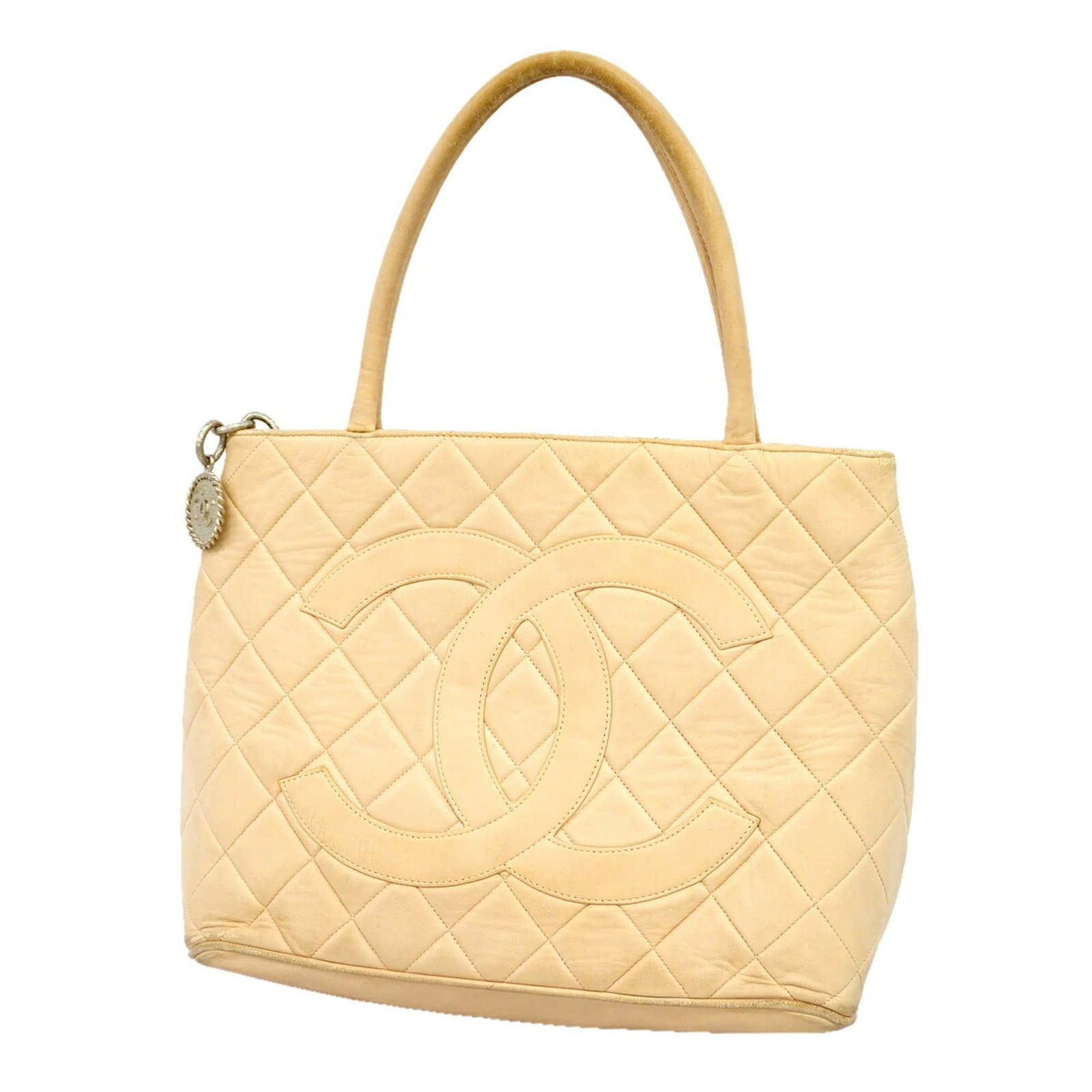 Leather Chanel Tote Bag: Leather Chanel Tote Bag This exquisite leather tote bag from Chanel features a timeless beige lambskin exterior with sleek silver hardware, perfectly balanced proportions, and a classic design that