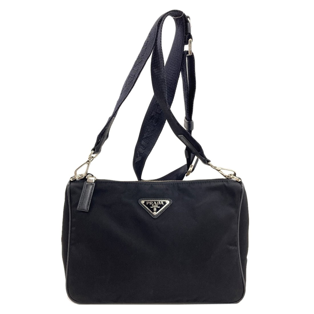 Shoulder Bag Nylon Prada Hardware Logo: Shoulder Bag Nylon Prada Hardware Logo Black nylon shoulder bag with a Prada hardware logo, measuring 7.1 inches in height and 2.8 inches in depth, features a zip closure and a 9.4-inch width. Made