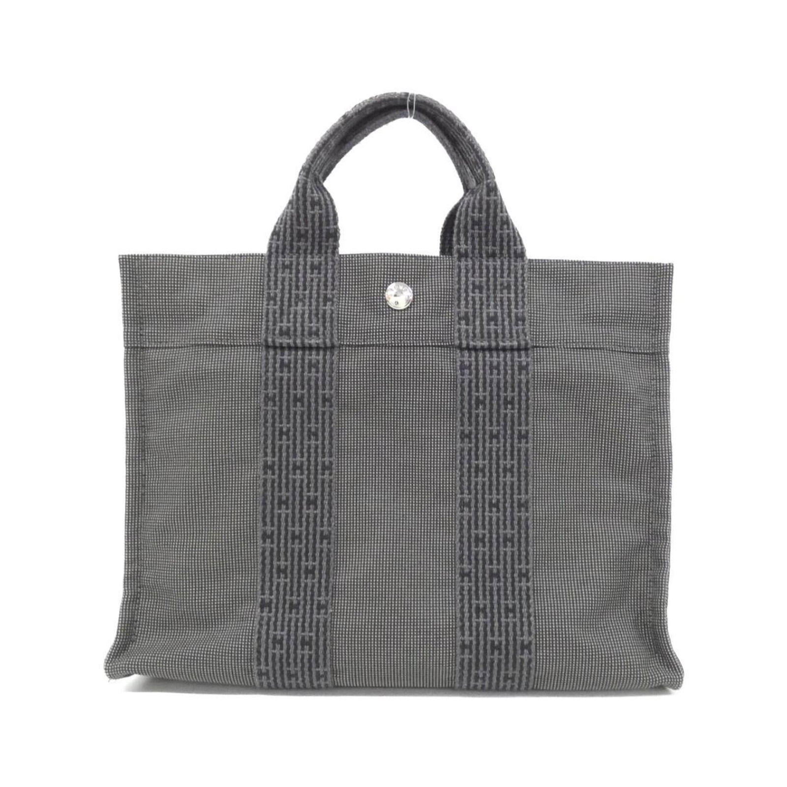 Handbag Canvas: Handbag Canvas Canvas handbag with a sleek black finish, measuring 23cm x 31cm x 8cm. The canvas material provides a sturdy and durable structure, while the signature bears a distinctive mark. This