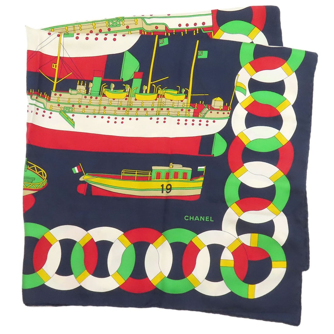 Silk scarf with boat motif by Chanel: Silk scarf with boat motif by Chanel Navy silk scarf with a classic boat motif, a timeless design that exudes elegance and sophistication. Made from high-quality silk, this scarf is a beautiful