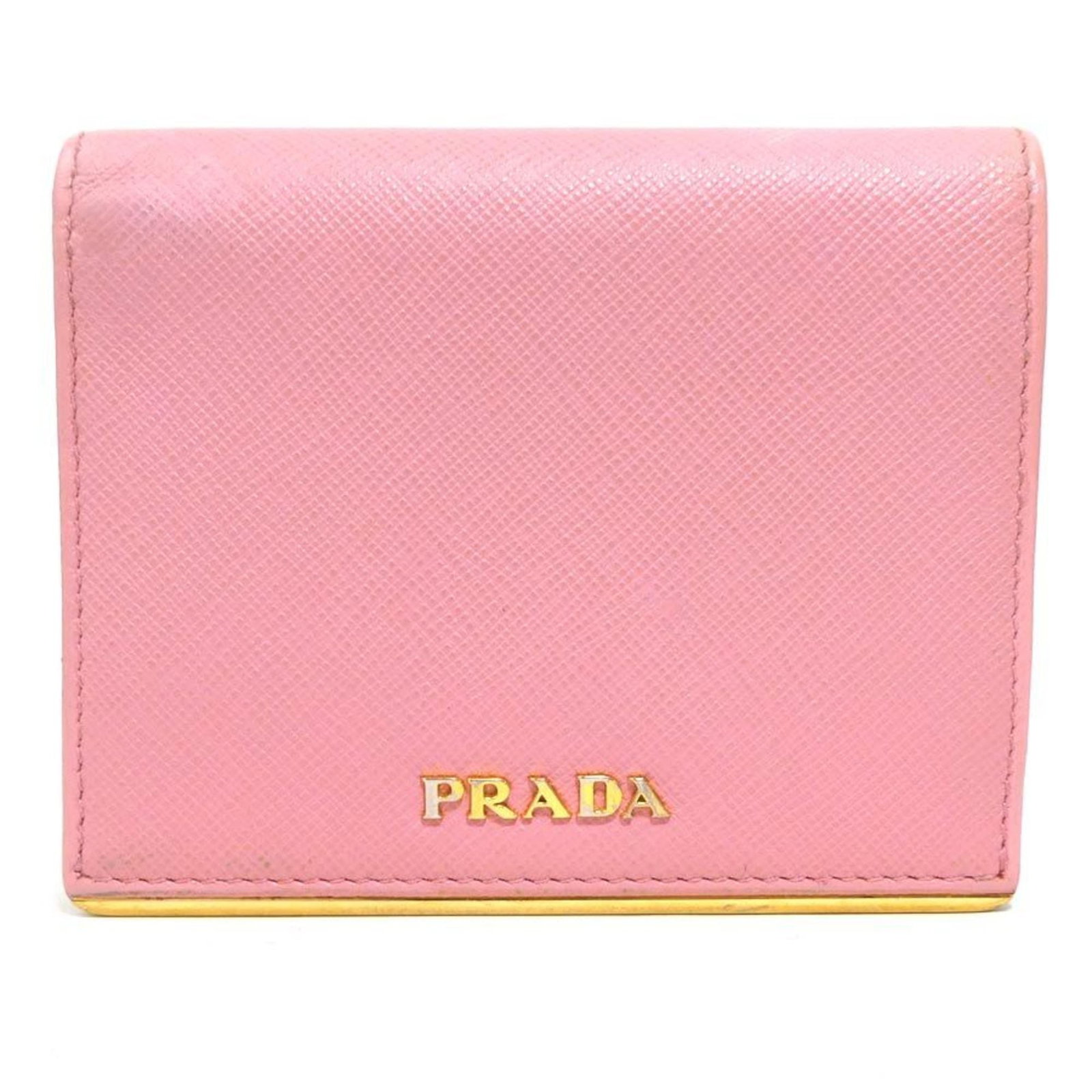 Bi fold leather wallet: Bi fold leather wallet Pink bi-fold leather wallet from Prada, measuring 9cm x 11cm x 2cm, comes with a box and shop card. This stylish wallet features high-quality leather construction and a classic