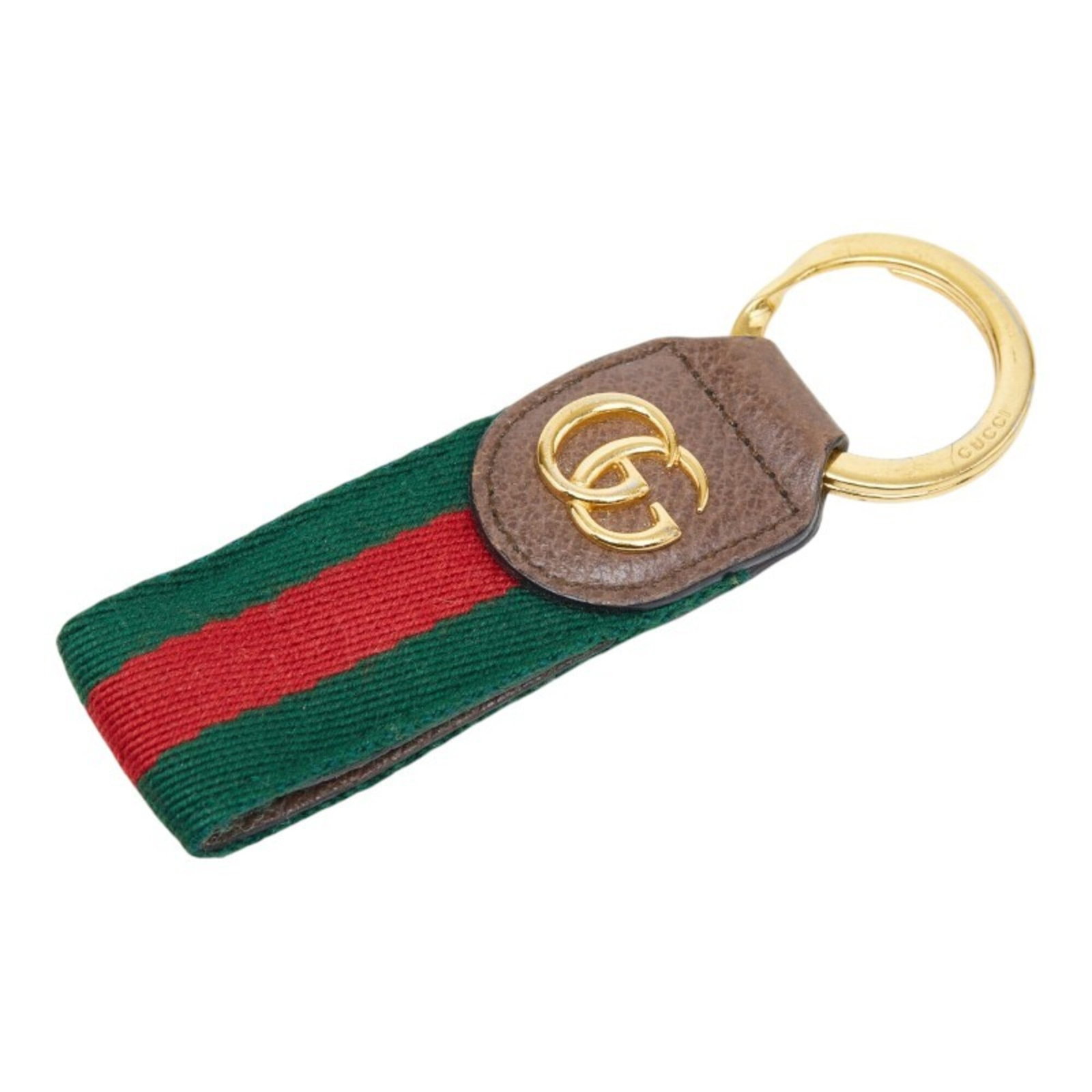 Keyring Gucci: Keyring Gucci This Gucci keyring boasts a sleek, brown leather design with a touch of gold accents, adding a sophisticated touch to any keychain. Measuring 11.5cm in length, the compact size makes it