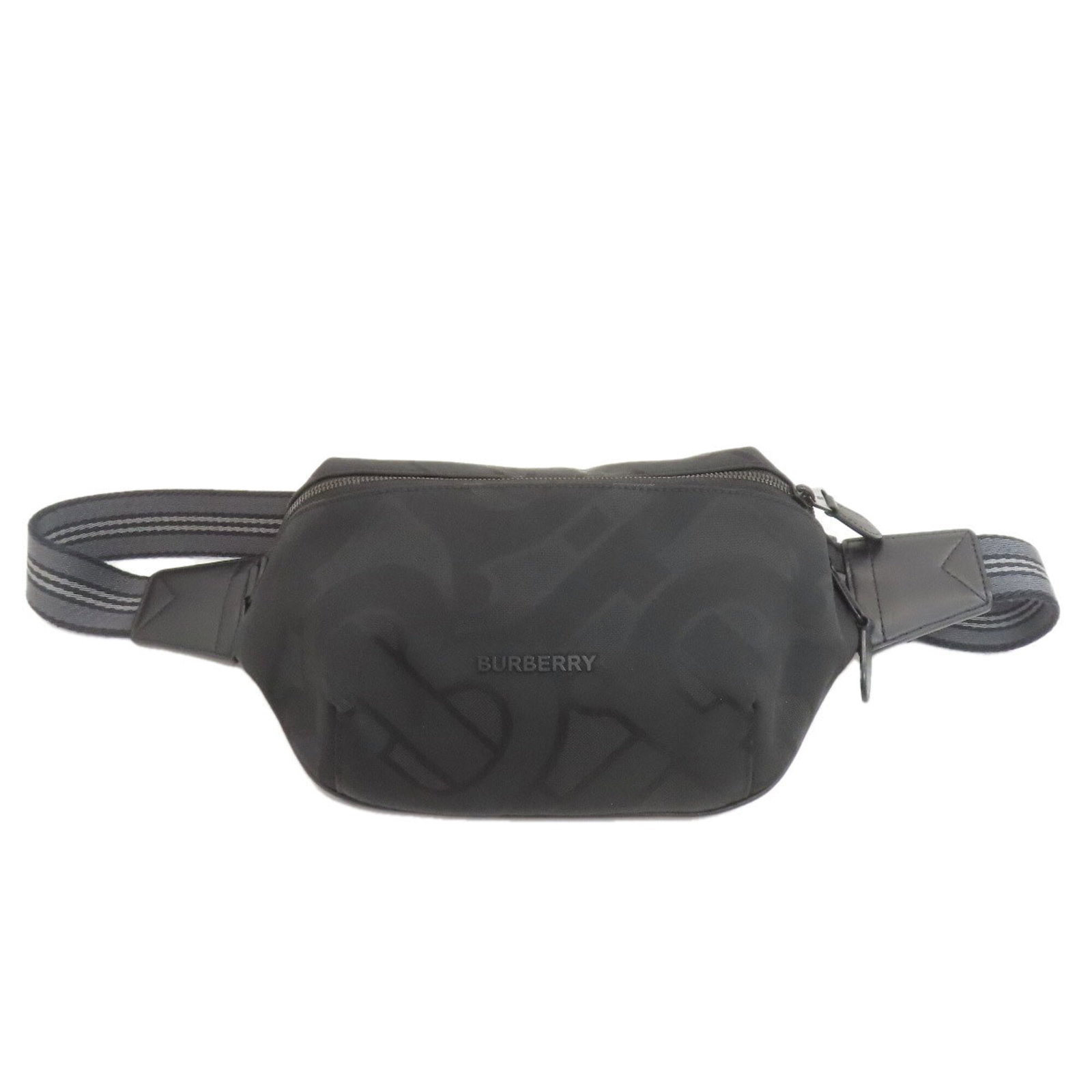 Nylon Canvas Sling Bag Burberry: Nylon Canvas Sling Bag Burberry Black nylon canvas sling bag from Burberry, measuring 15cm x 30cm x 1cm. This compact bag features a classic design with a durable nylon canvas material. The sleek