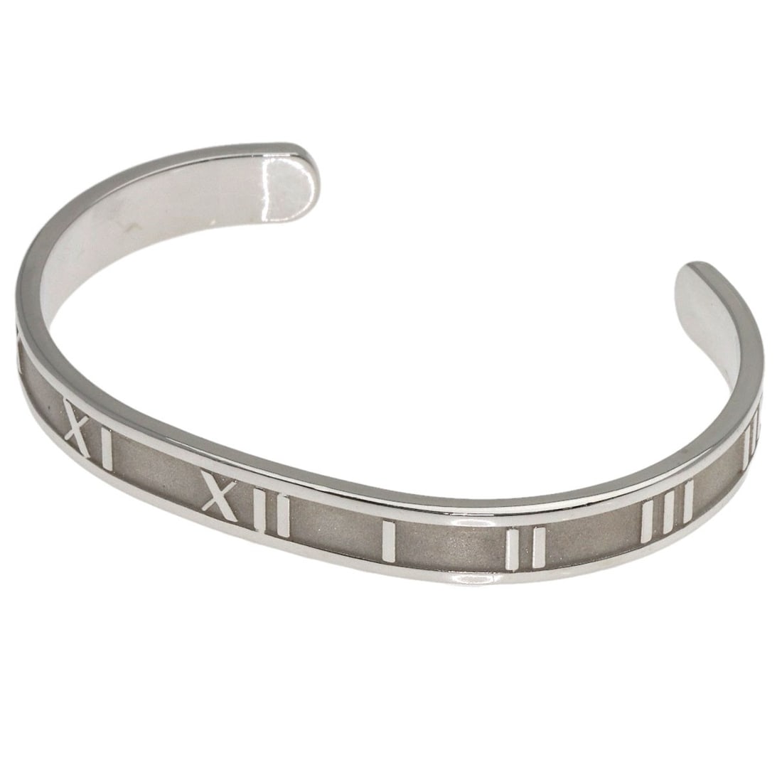 Atlas Bangle Silver by Tiffany&Co: Atlas Bangle Silver by Tiffany&Co Silver bangle from Tiffany&Co. features a sleek, silver design with no stone. Made from high-quality silver metal, this classic bracelet is a timeless accessory. The 