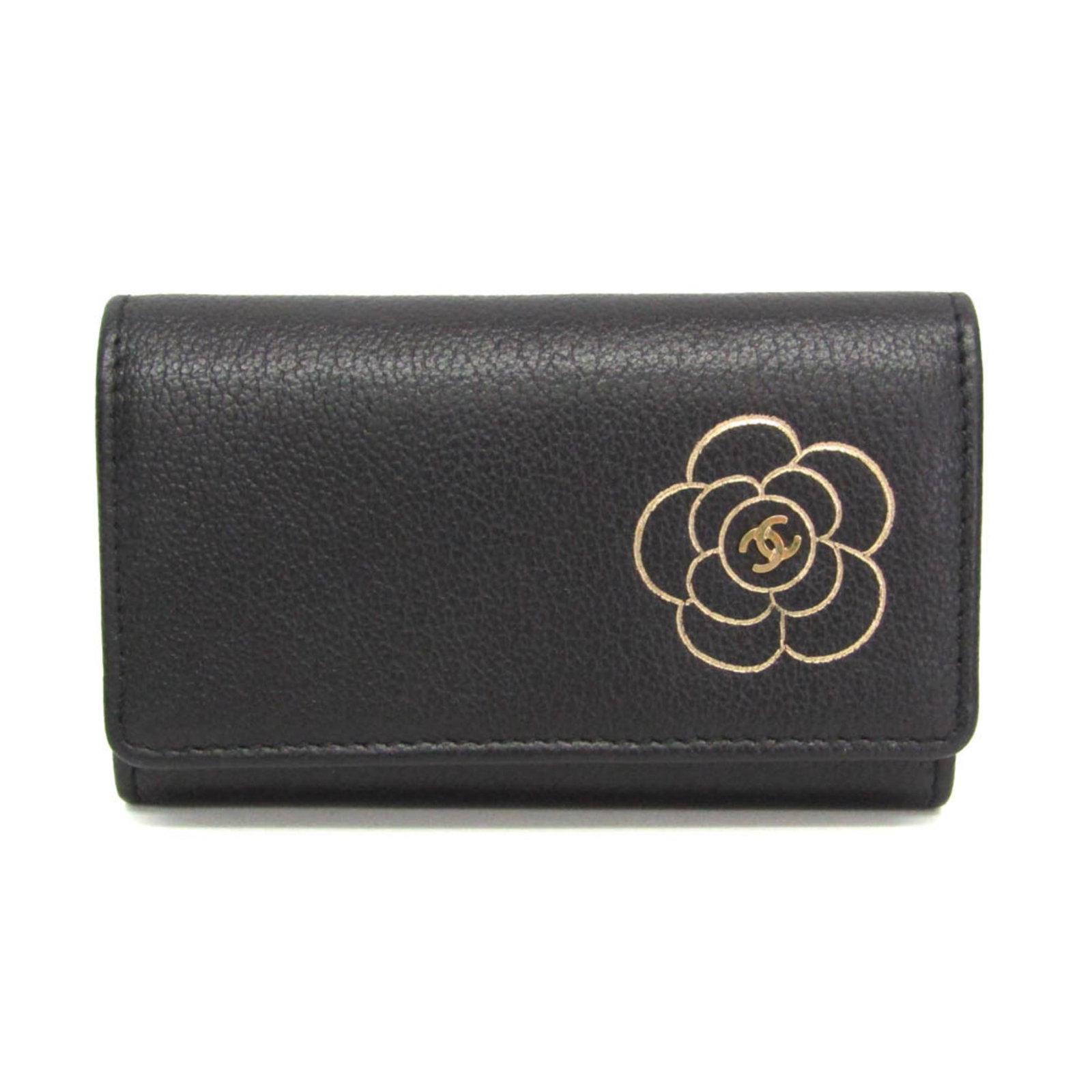 Keycase leather by Chanel: Keycase leather by Chanel The Keycase leather by Chanel is a sleek and sophisticated accessory, crafted from high-quality black leather. This compact keycase features a snap fastener closure and six k