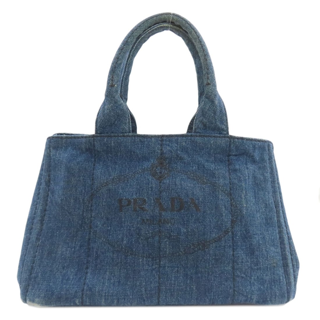 Canapa Tote Bag Denim By Prada: Canapa Tote Bag Denim By Prada Brown Denim Tote Bag from PRADA. Made from high-quality denim, this stylish tote bag features a classic design with a brown exterior. A timeless accessory for everyday
