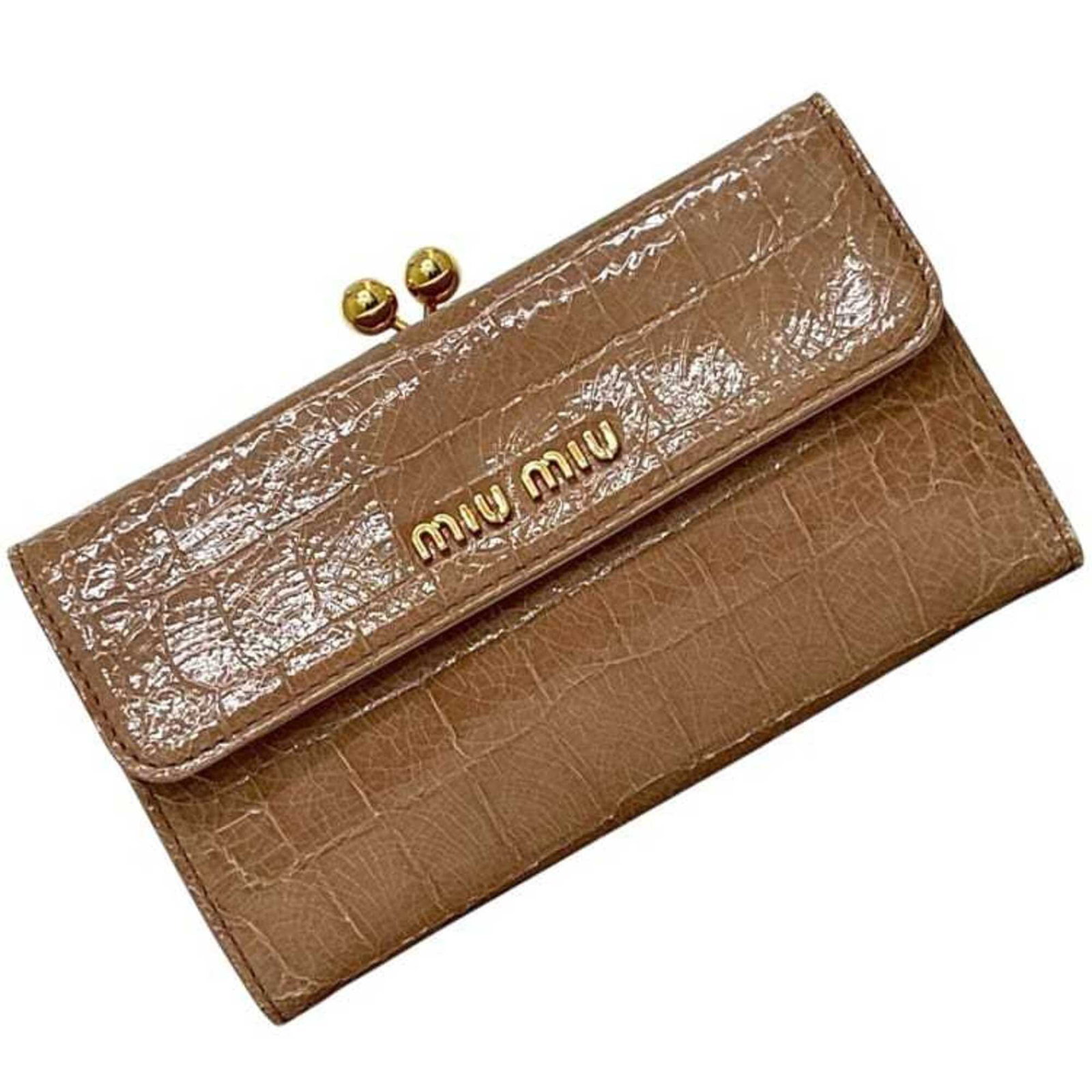 Miu Wallet (Bi-Fold) Patent Leather: Miu Wallet (Bi-Fold) Patent Leather Patent leather finishes the classic design of this bi-fold Miu Miu wallet, available in a timeless beige color. Measuring 8.7cm x 14.7cm x 3cm, it provides a sleek