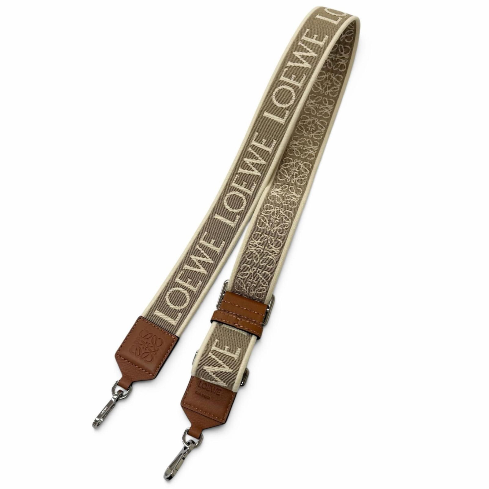 Leather Strap Canvas Loewe: Leather Strap Canvas Loewe Canvas and leather come together in this unique Loewe design, featuring a beige and brown color combination. The item measures 98cm x 4cm x 1.57cm and is made from a combina