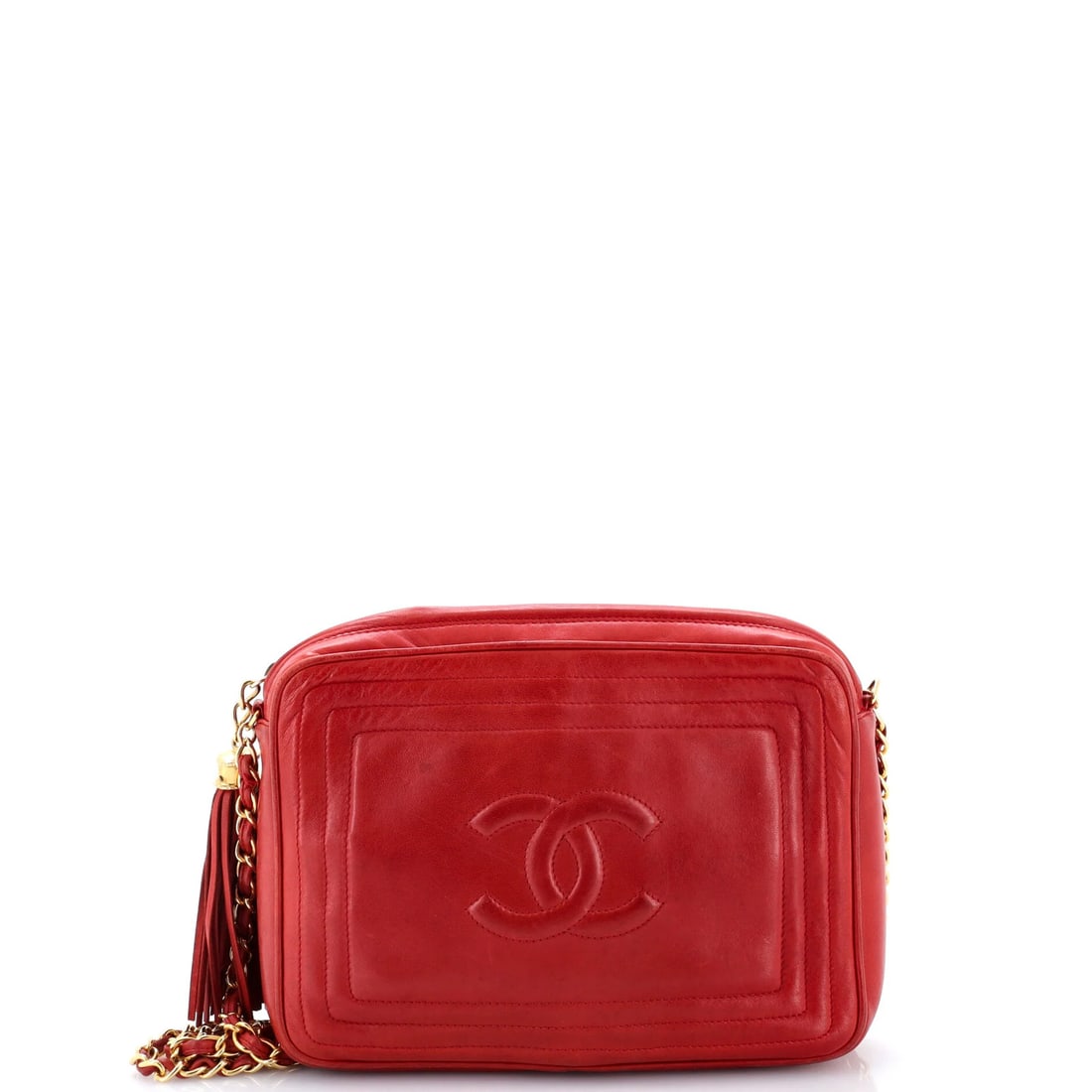 Small lambskin camera bag tassel vintage Chanel: Small lambskin camera bag tassel vintage Chanel Small lambskin camera bag tassel vintage Chanel features a classic cross body design with a bold red exterior and gold hardware. The bag's interior is