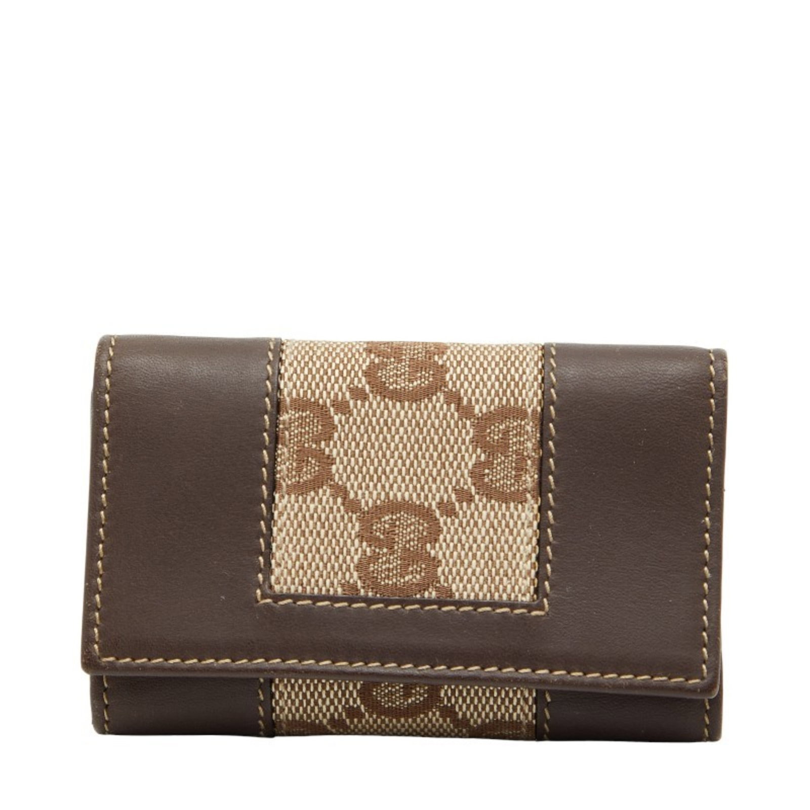 Canvas leather keycase by Gucci: Canvas leather keycase by Gucci Canvas leather keycase by Gucci, a stylish and functional accessory in brown, measures 6cm x 9.5cm x 1.5cm. The item comes with a box, providing a convenient way to sto