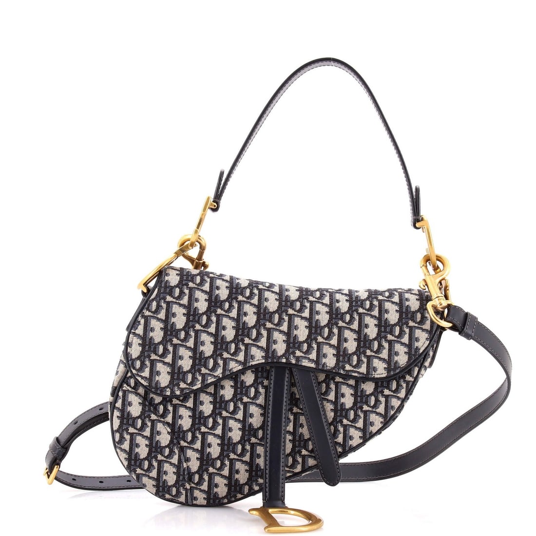 Saddle Handbag Strap Oblique Canvas Medium Christian Dior: Saddle Handbag Strap Oblique Canvas Medium Christian Dior Saddle Handbag with Strap Oblique Canvas Medium from Christian Dior features a striking blue canvas exterior with oblique design, showcasing