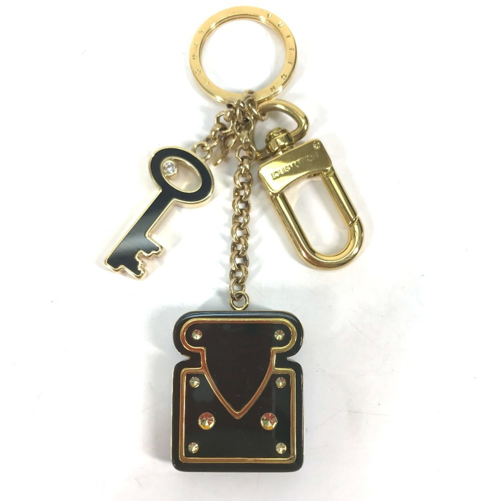 Keyring metal plastic Louis Vuitton rhinestone: Keyring metal plastic Louis Vuitton rhinestone Metal, plastic, and rhinestone details come together in a Louis Vuitton keyring, finished in black. The item includes a box and dust bag for storage. Thi