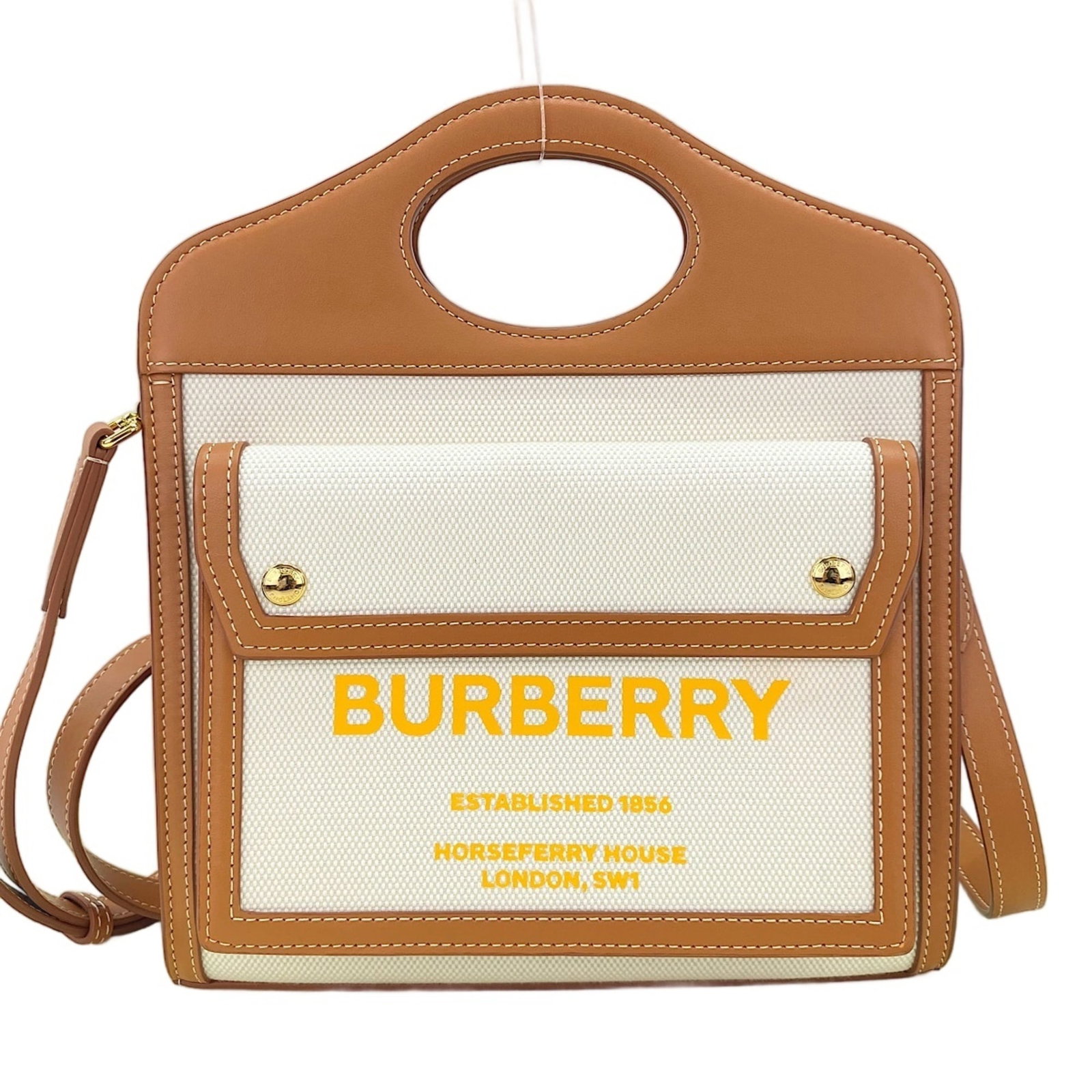 Burberry Handbag: Burberry Handbag Burberry's iconic handbag boasts a crisp white finish, measuring 27cm x 23cm x 4.5cm, making it a stylish and compact accessory. Crafted from high-quality materials, this handbag is