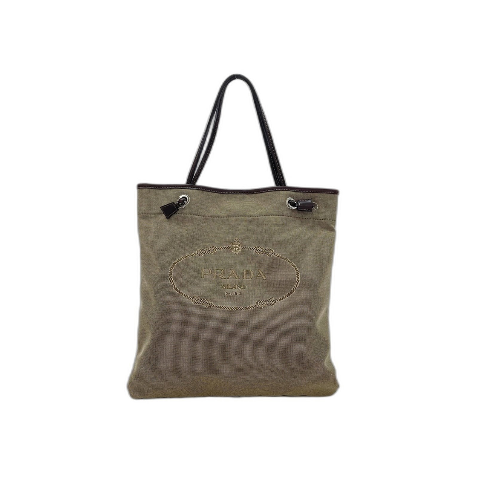 Canvas Prada Tote: Canvas Prada Tote Canvas Prada Tote in Brown, 36cm x 33cm x 1cm, with a 20cm handle drop. This canvas tote bag features a classic design and a signature style from the renowned Italian fashion brand,