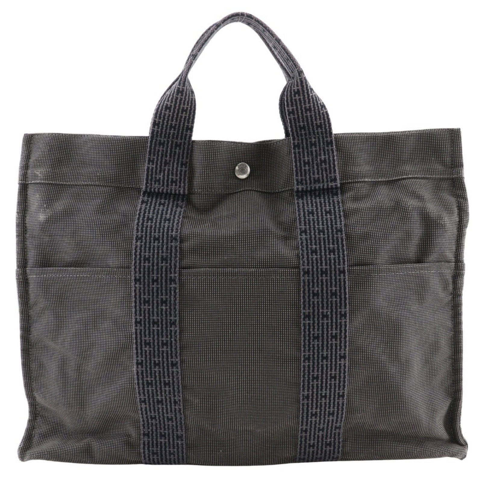 Nylon Canvas Handbag by Hermes: Nylon Canvas Handbag by Hermes Nylon canvas handbag by Hermes, featuring a sturdy and versatile design with a gray color. Made from high-quality nylon canvas, this bag measures 31cm x 42cm x 11cm and