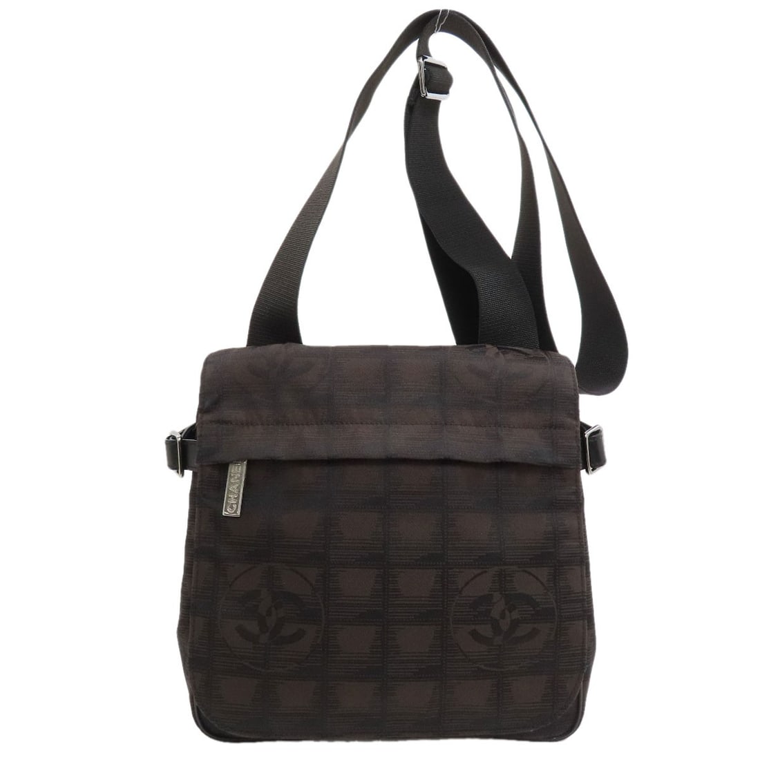 Nylon New Shoulder Bag Chanel Travel Line: Nylon New Shoulder Bag Chanel Travel Line Brown Nylon Shoulder Bag with Magnetic Closure from Chanel's Travel Line, featuring a jacquard exterior and measuring 8.7 inches in height and 8.3 inches in