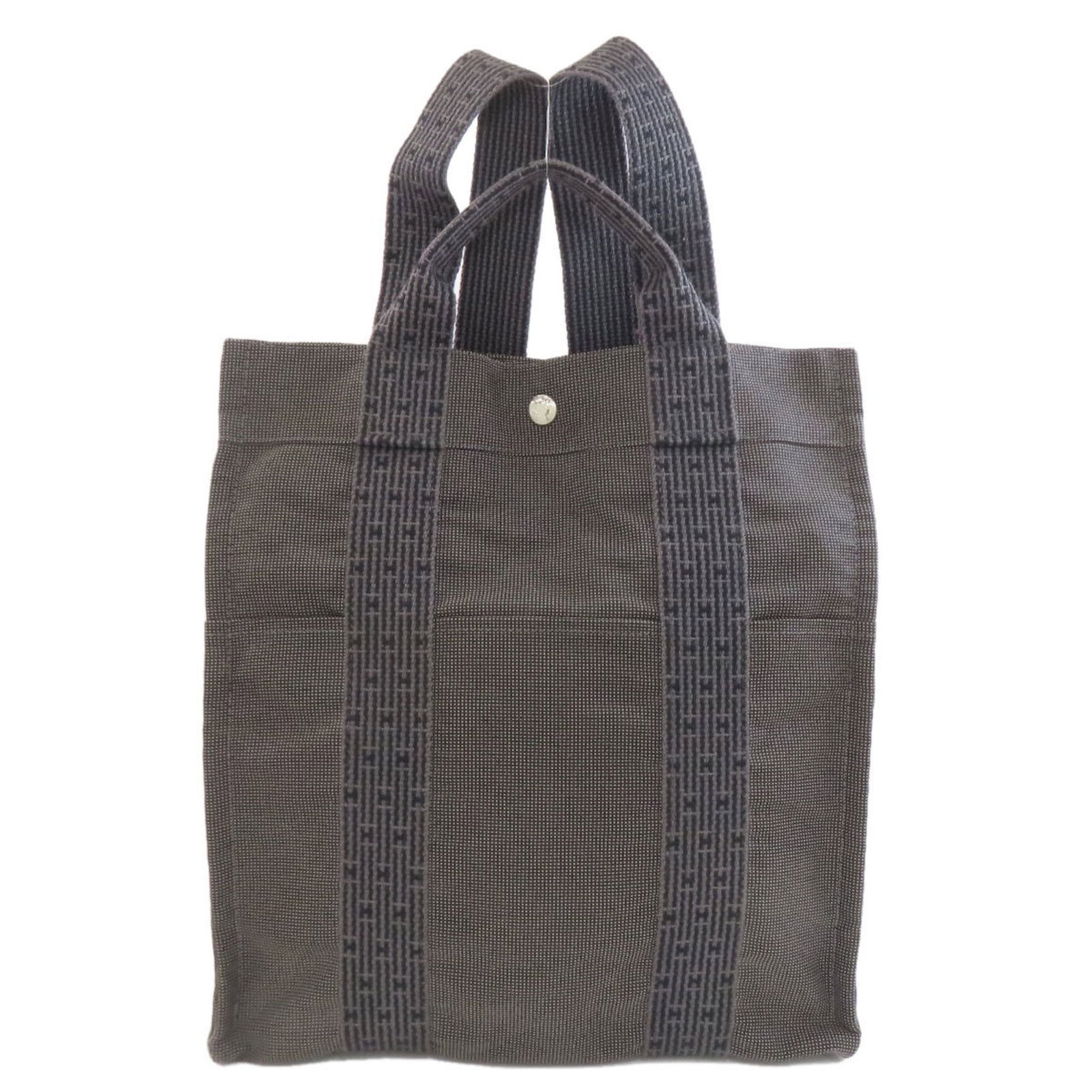 Hermes Canvas Backpack: Hermes Canvas Backpack Gray canvas backpack from Hermes with dimensions of 34cm x 30cm x 12cm. This stylish backpack features a classic design and a durable canvas material. Item Specifics: Brand: