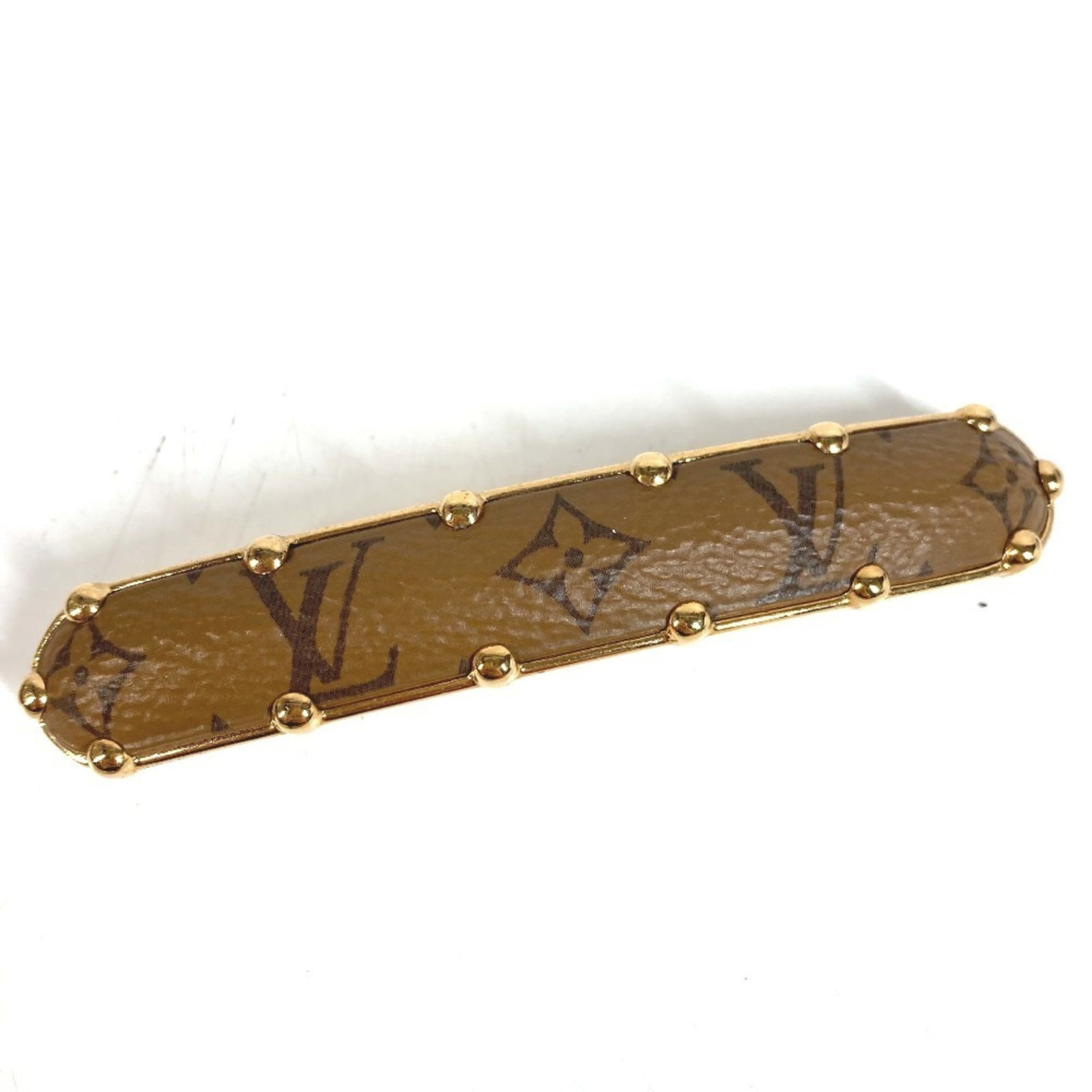 Vuitton Louis Barrette Monogram Reverse: Vuitton Louis Barrette Monogram Reverse The Louis Vuitton Louis Barrette Monogram Reverse is a stylish accessory featuring the iconic Monogram Reverse pattern in a rich brown color. Measuring 9cm x